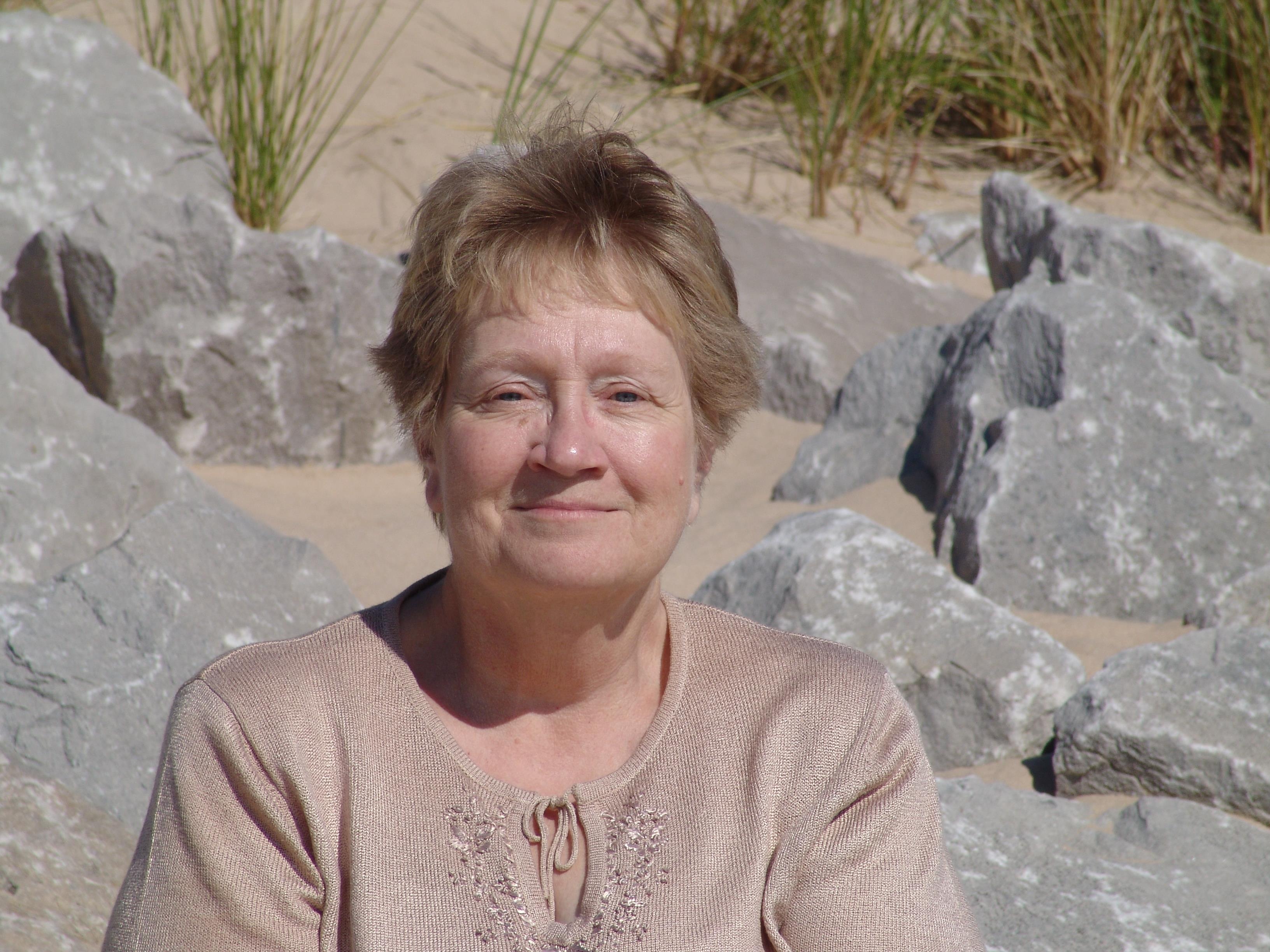 A woman sitting on a rock