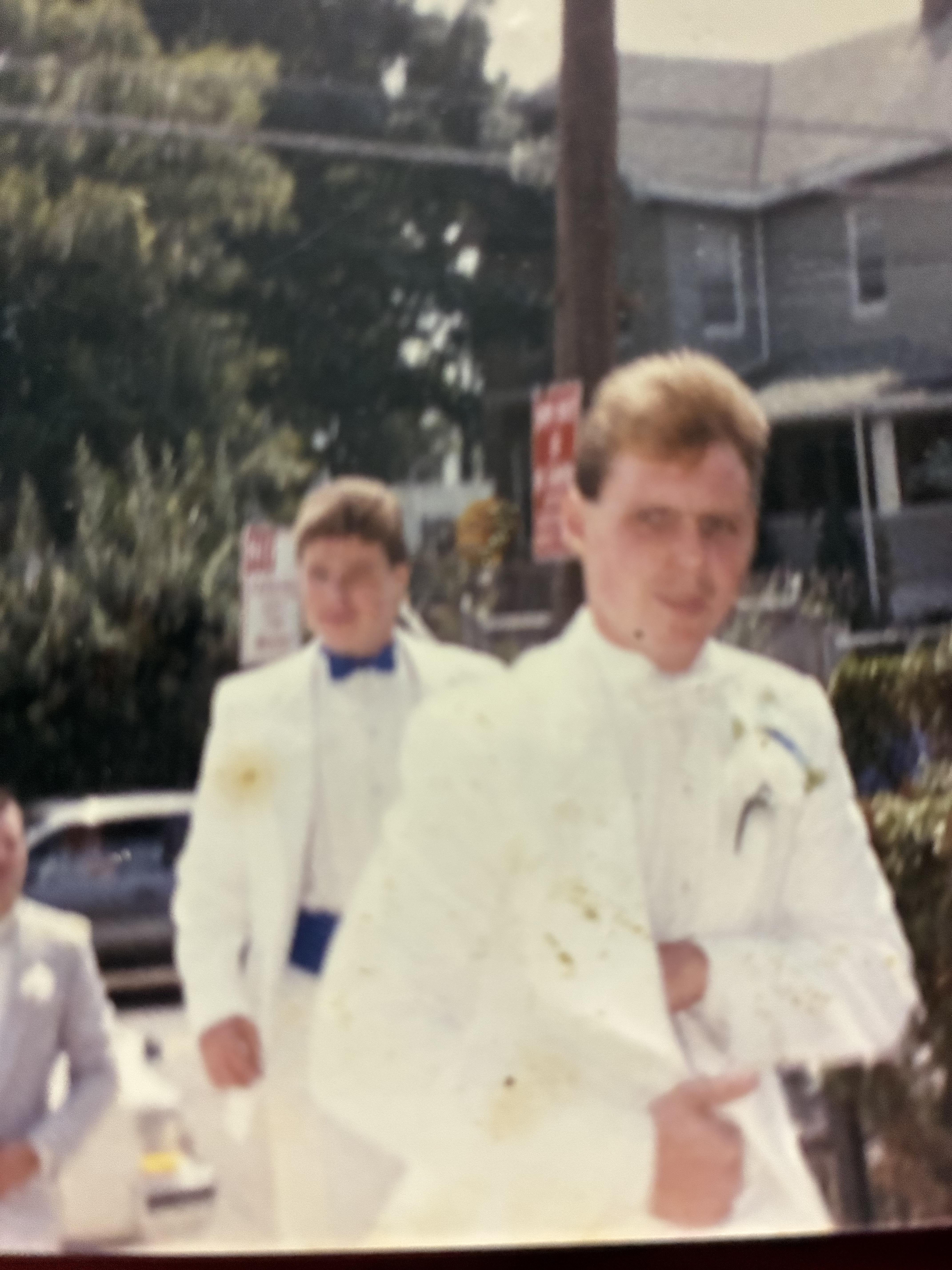 A blurry image of a man in white suit