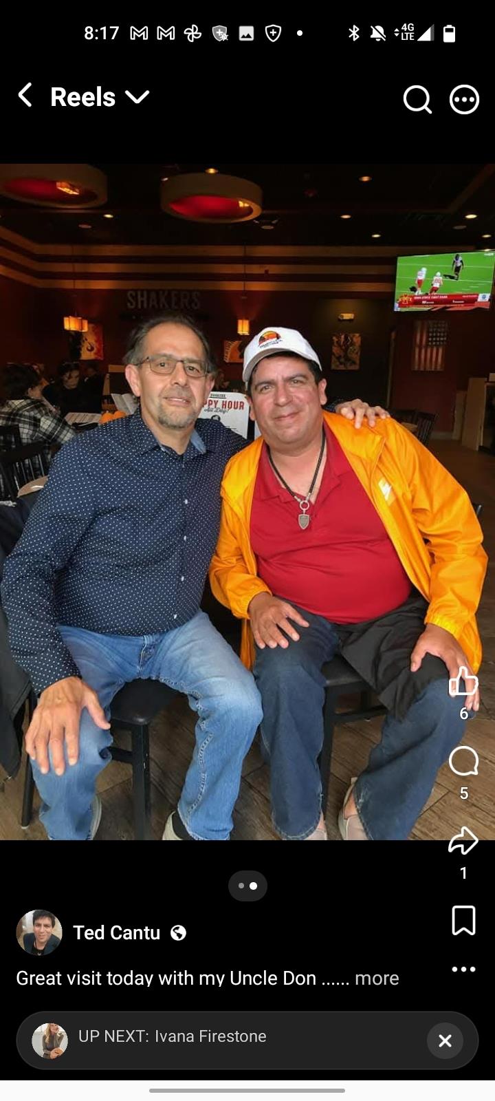 Two men sitting together smiling
