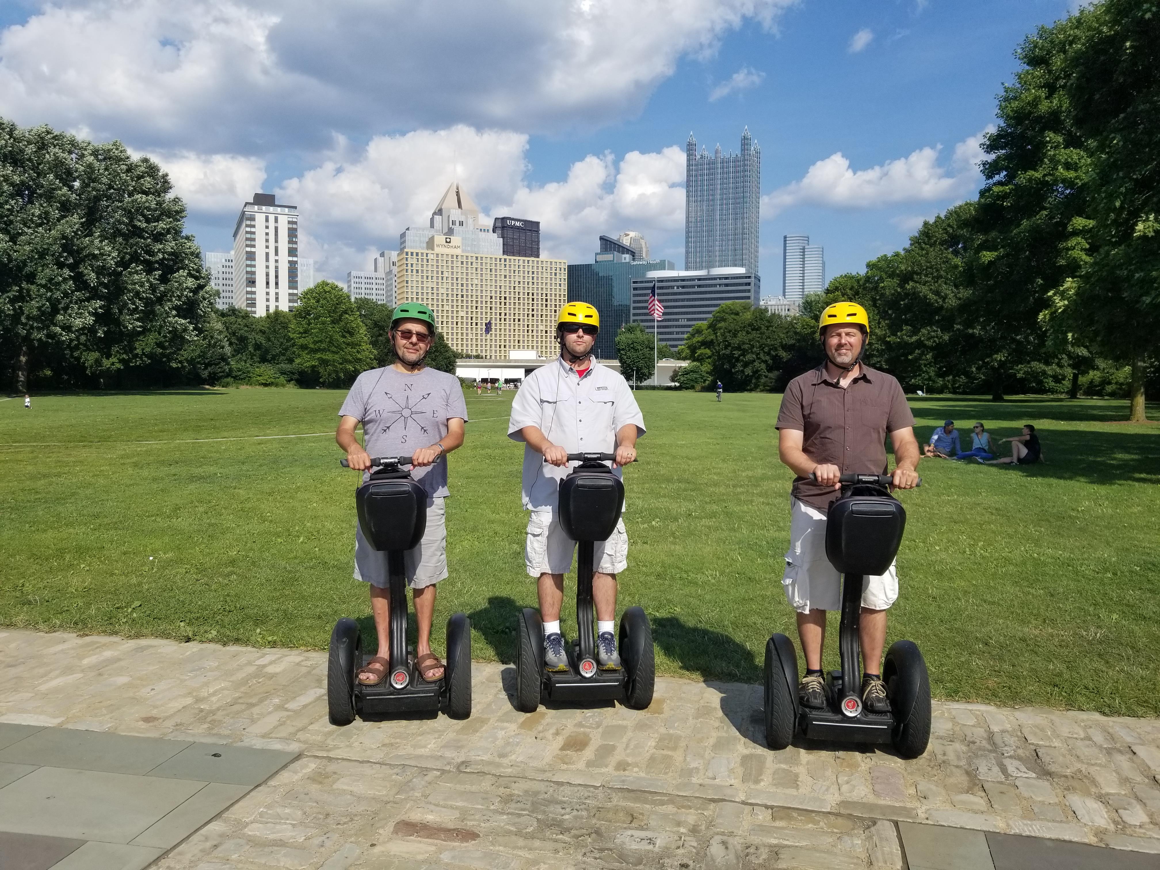 A group of men on segways in a park