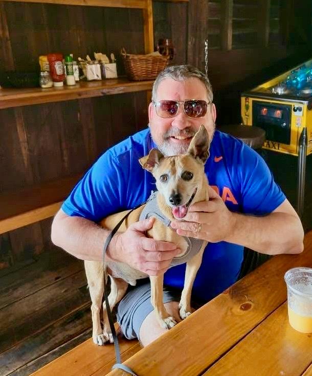 A man holding a dog