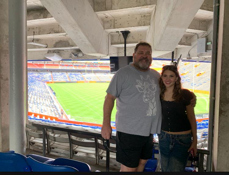 A man and woman standing in a stadium
