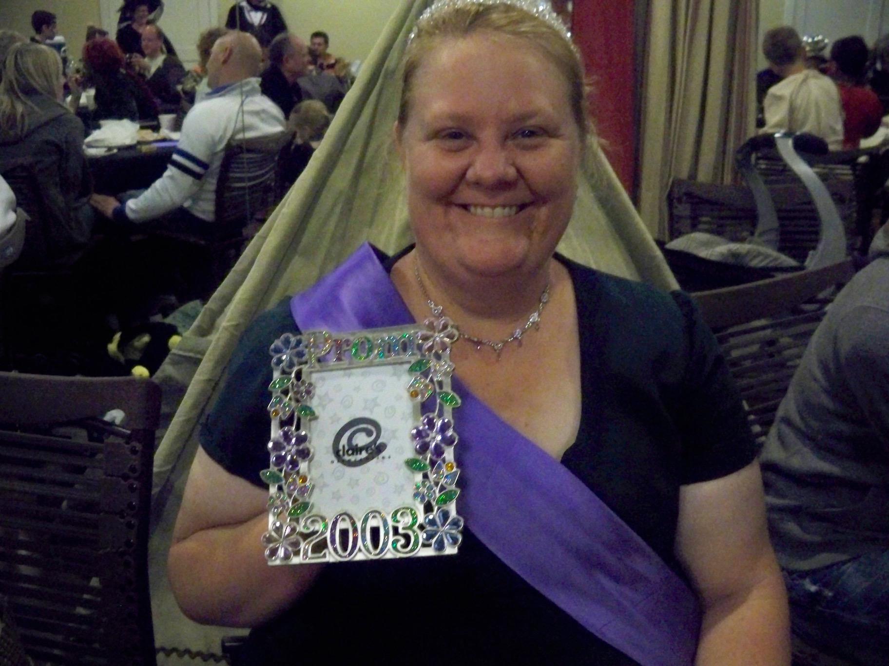 A woman holding a medal