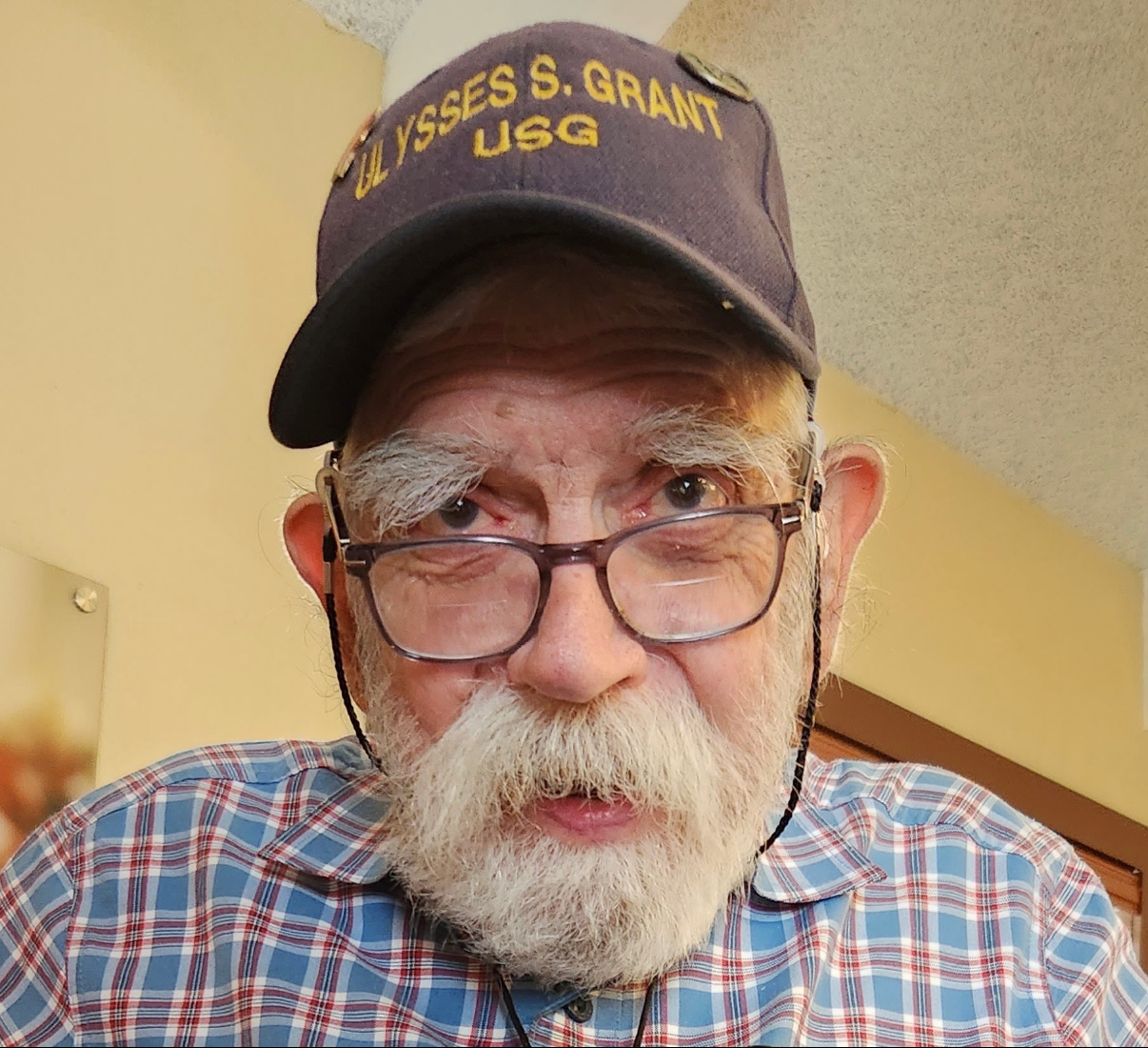 A man with a beard and glasses