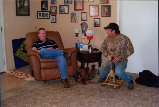 A man sitting in a chair next to another man