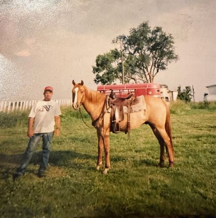 A man standing next to a horse