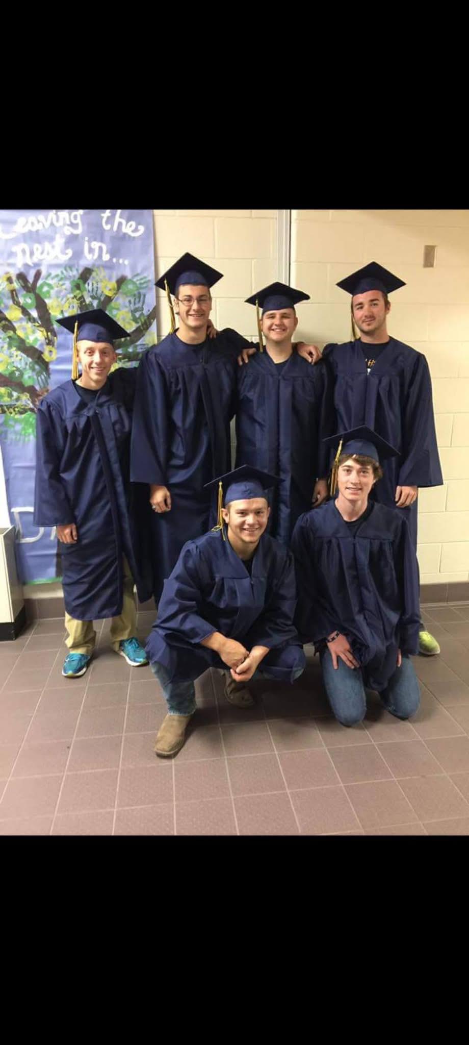 A group of people in graduation gowns and caps