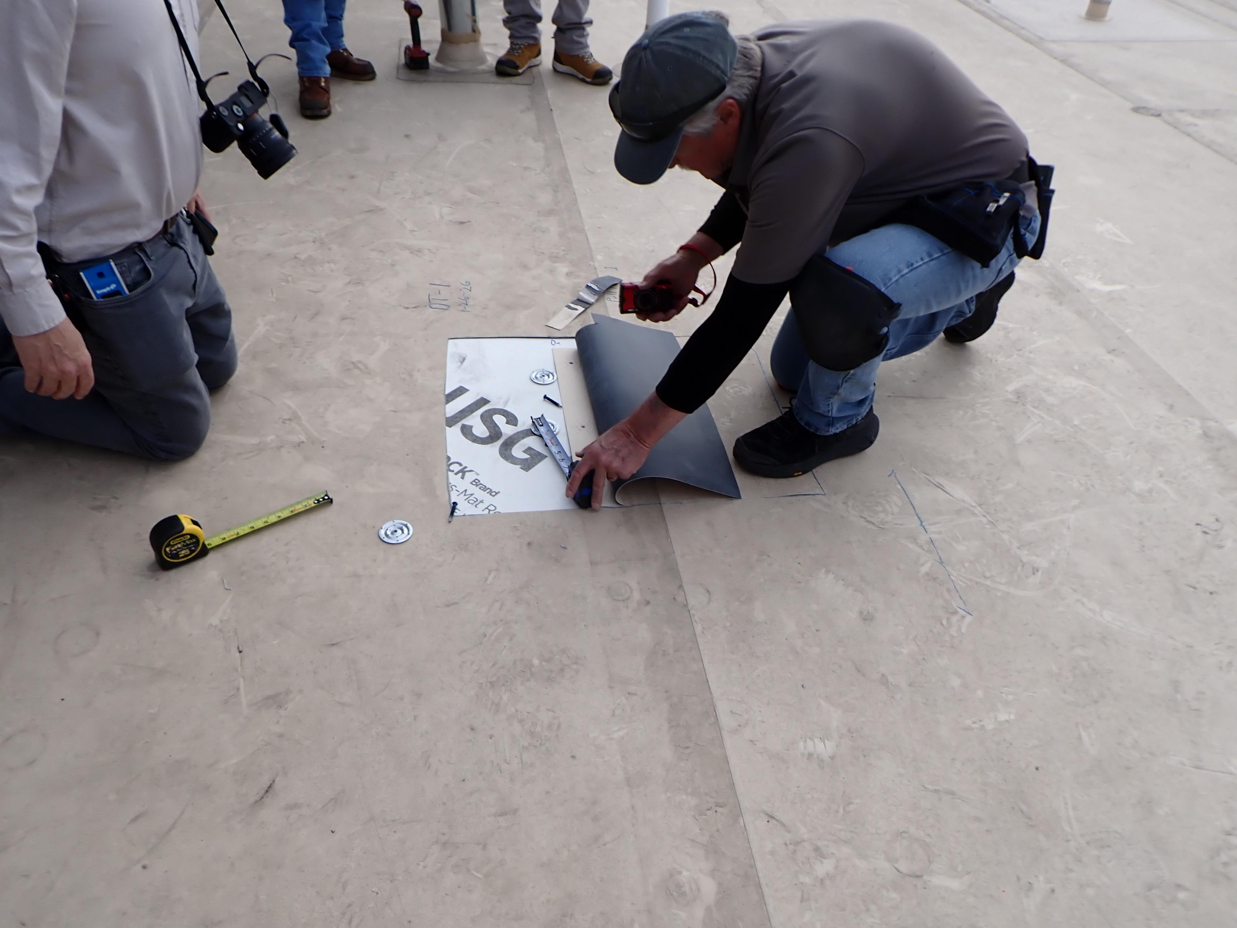 A man measuring a piece of paper