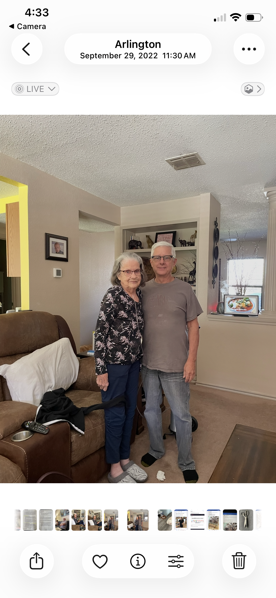 A man and woman standing in a living room