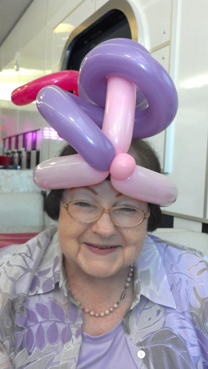 A woman wearing a hat made of balloons