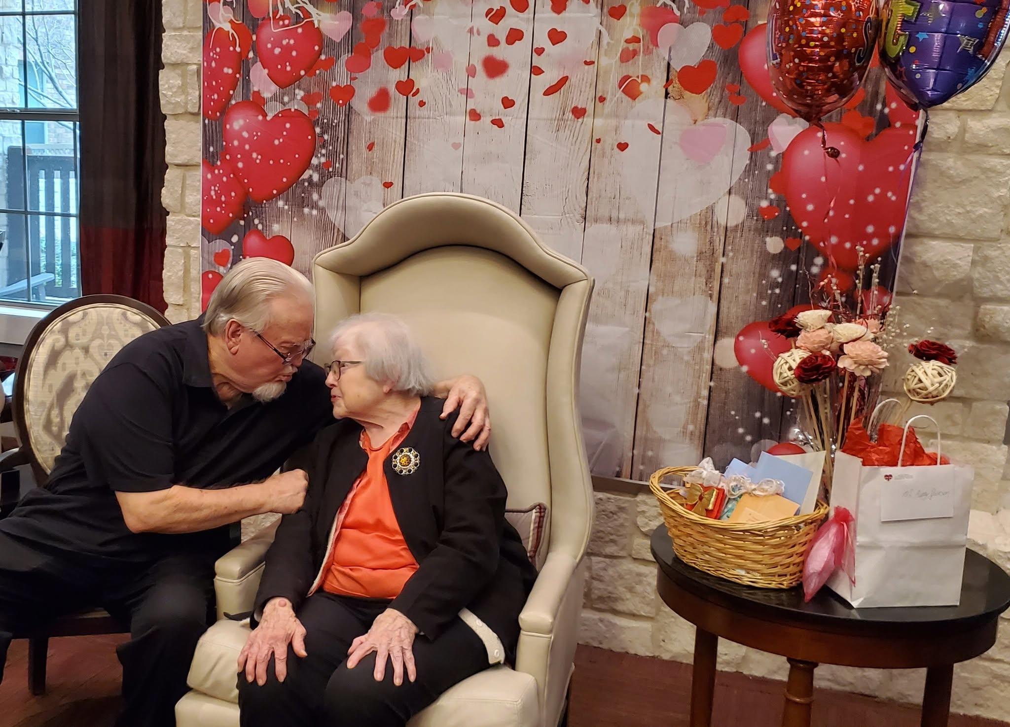 A man and woman sitting in a chair