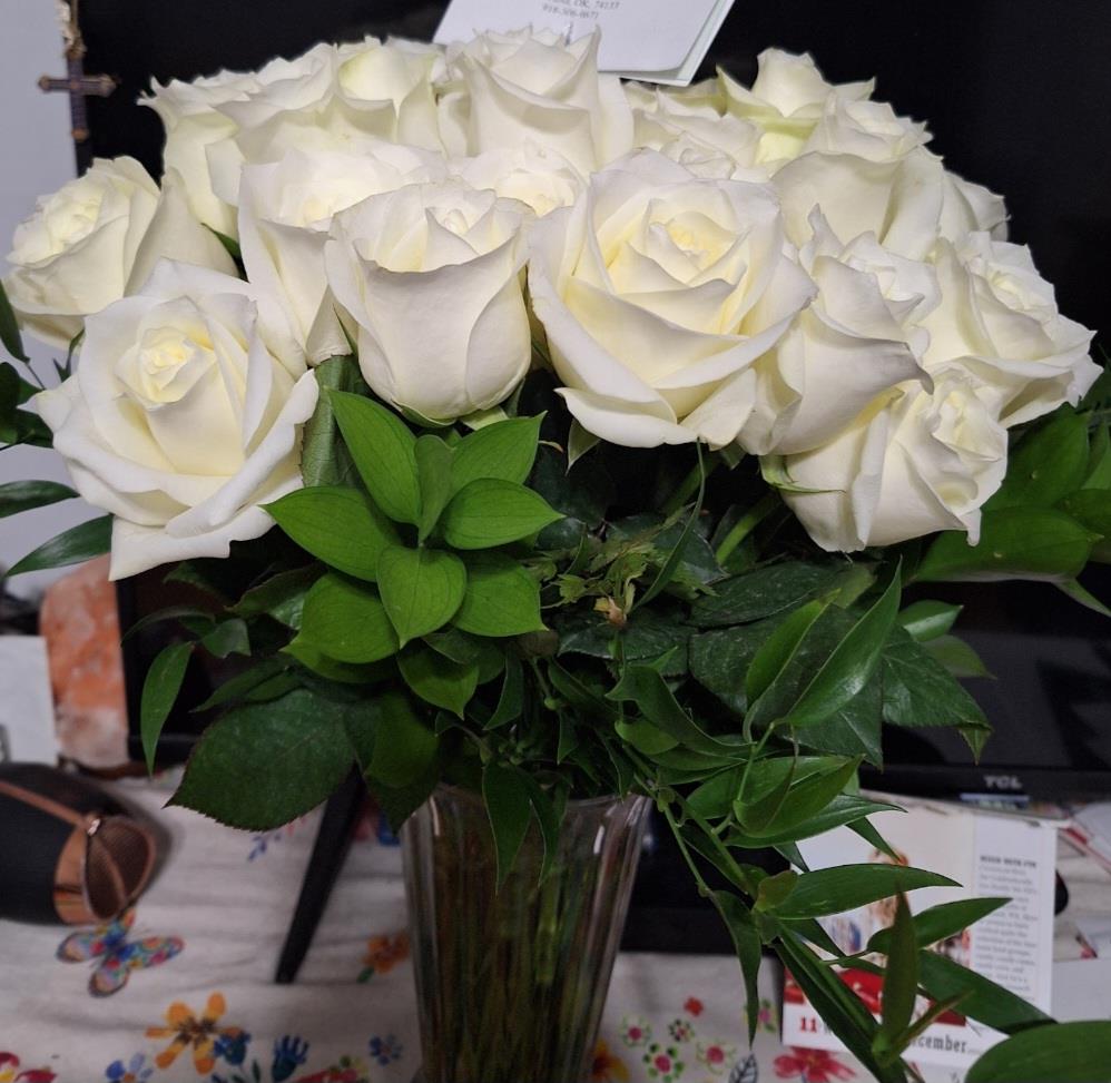 A bouquet of white roses in a vase