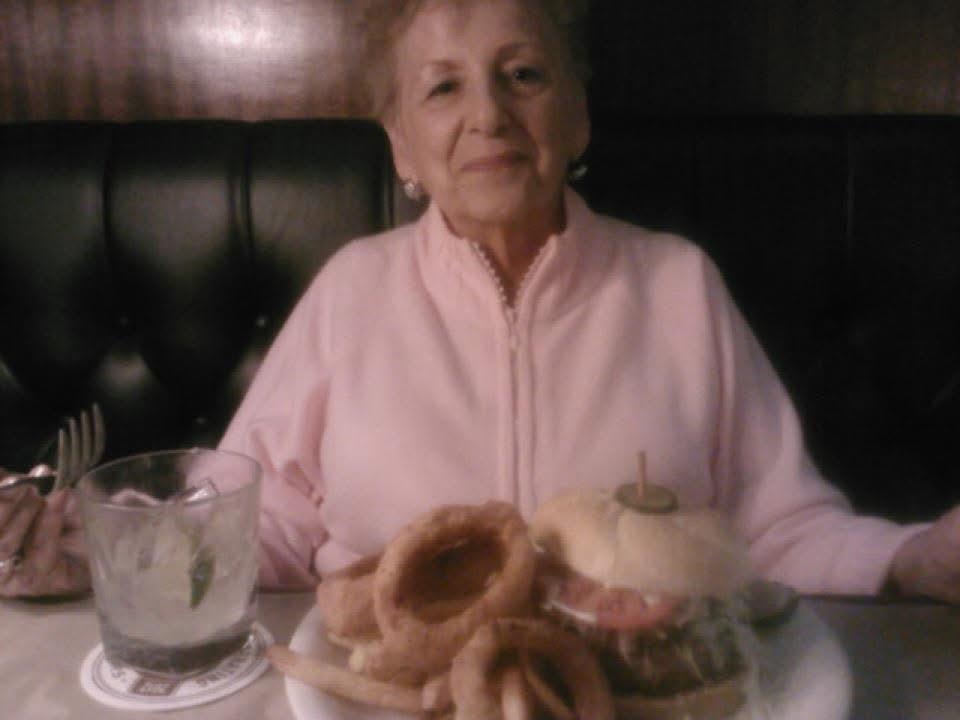A woman sitting at a table with a plate of food