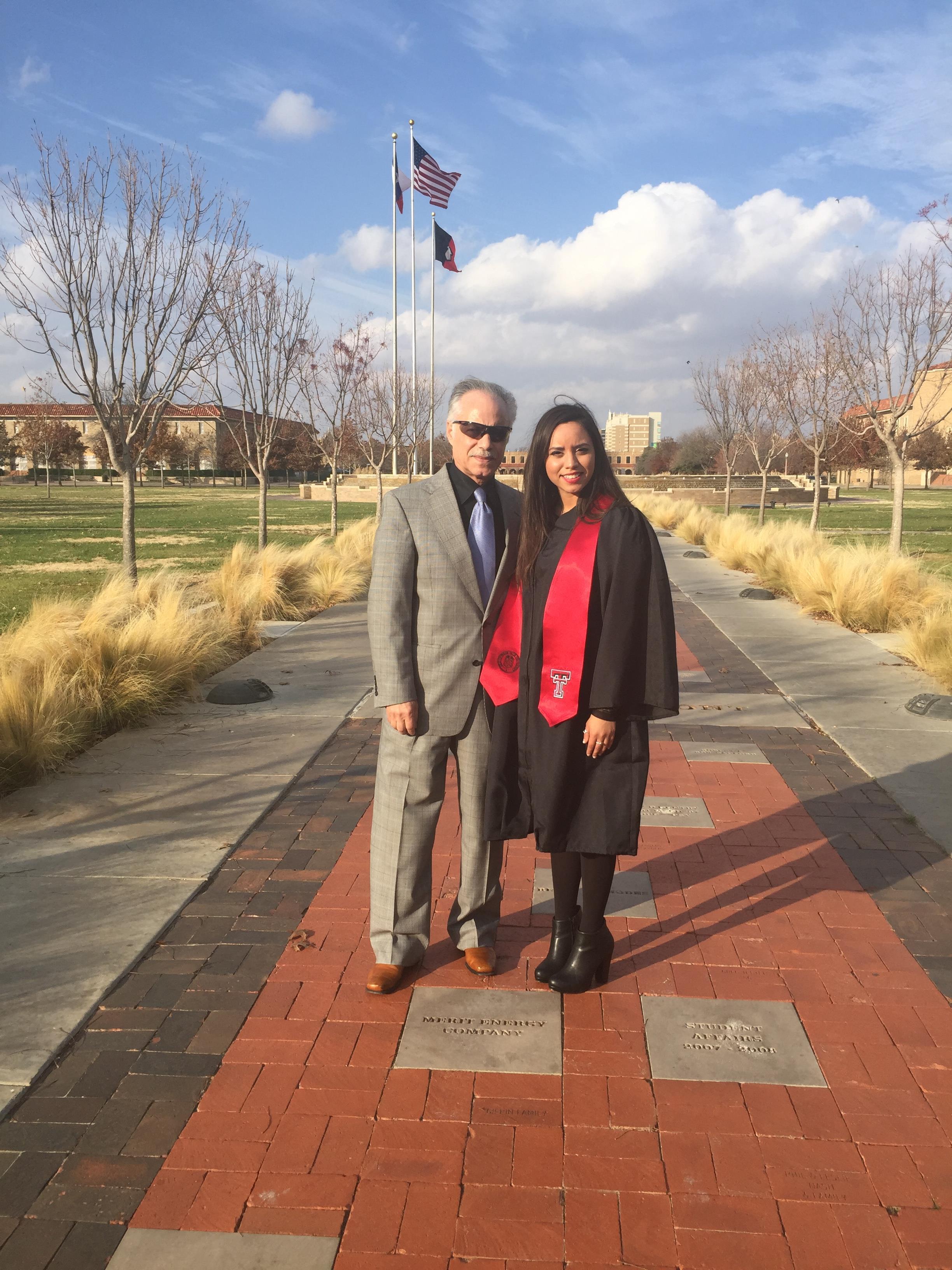 A man and woman standing on a brick walkway