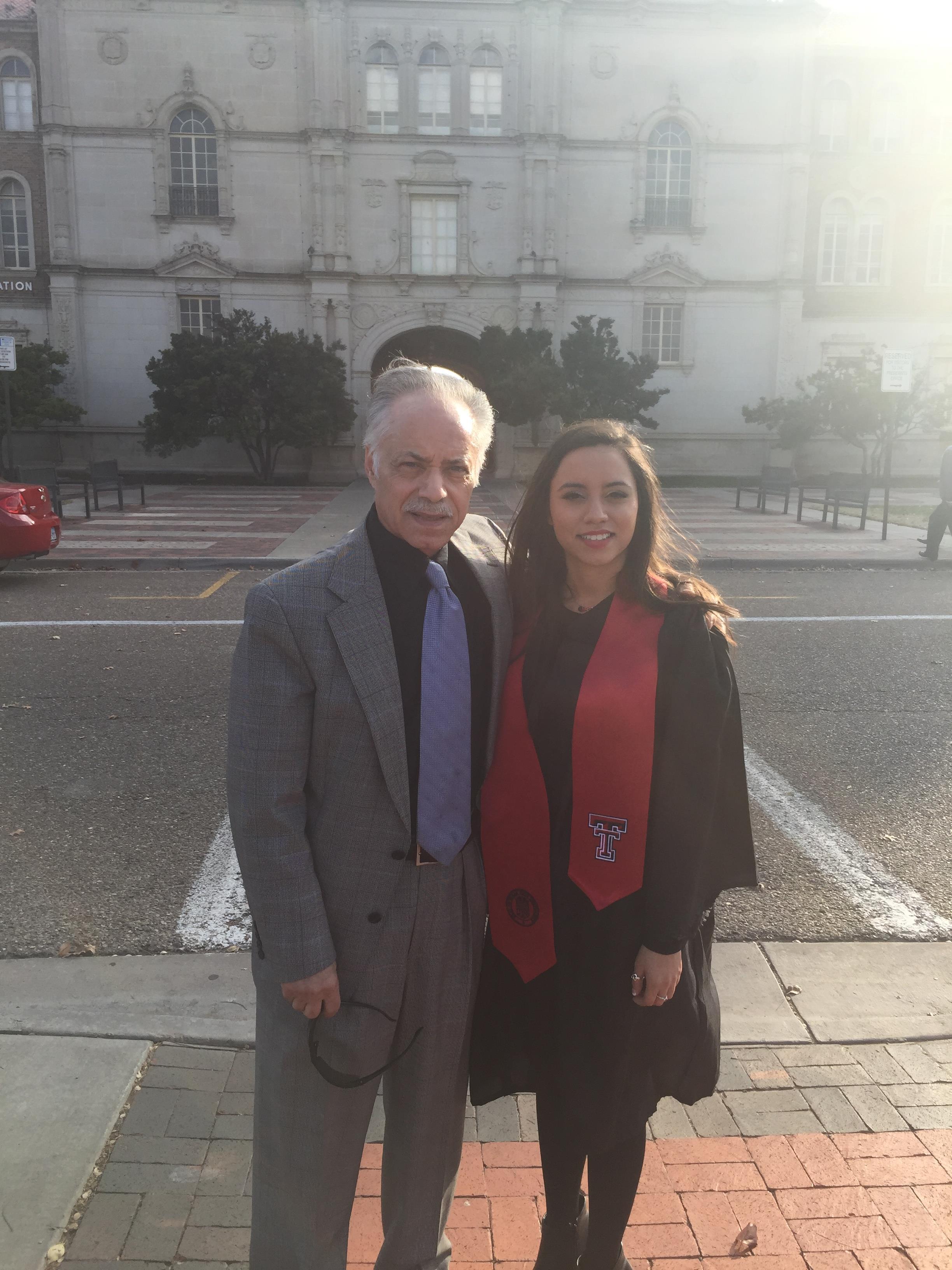 A man and woman standing on a sidewalk