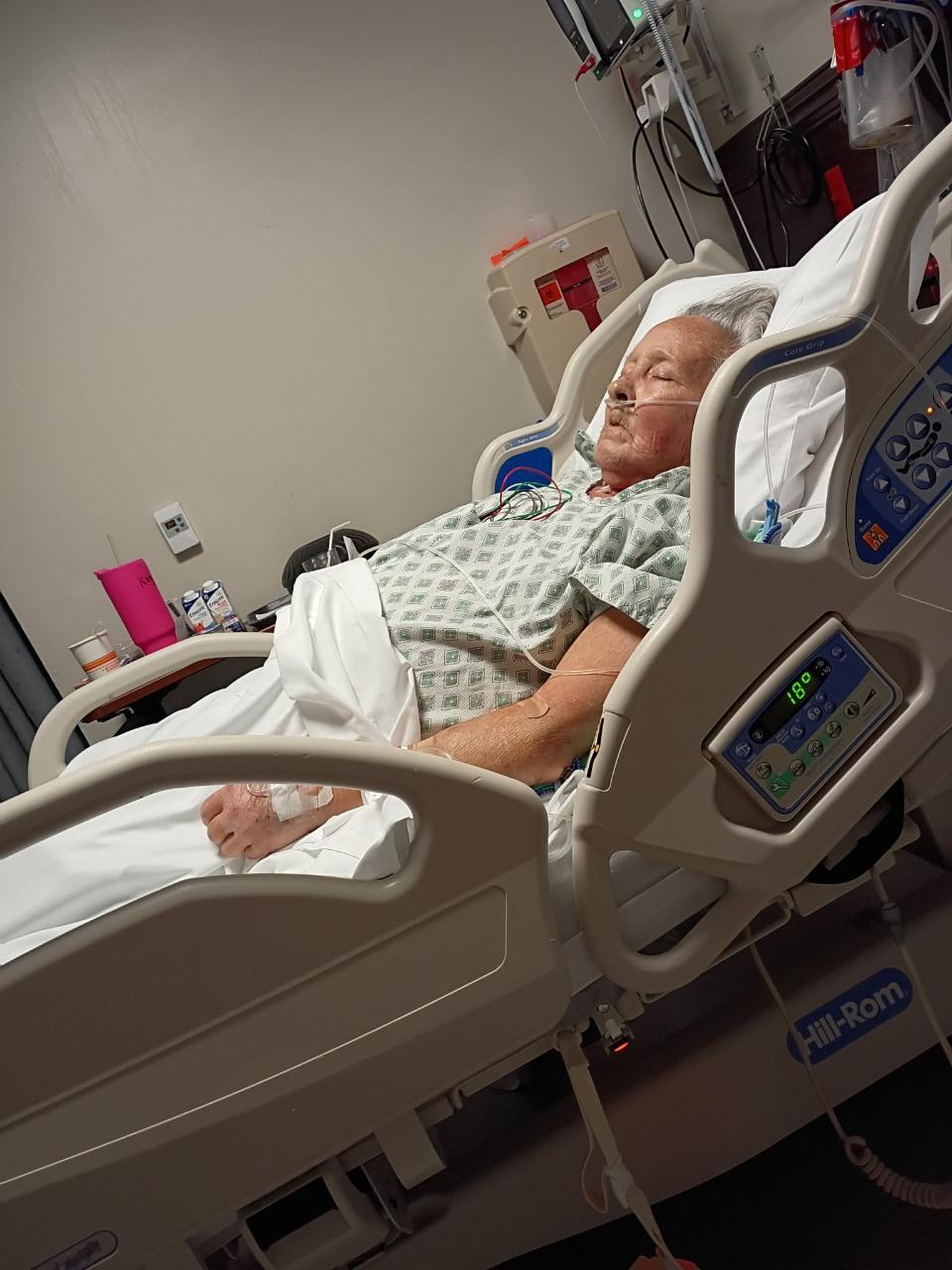 A person lying in a hospital bed