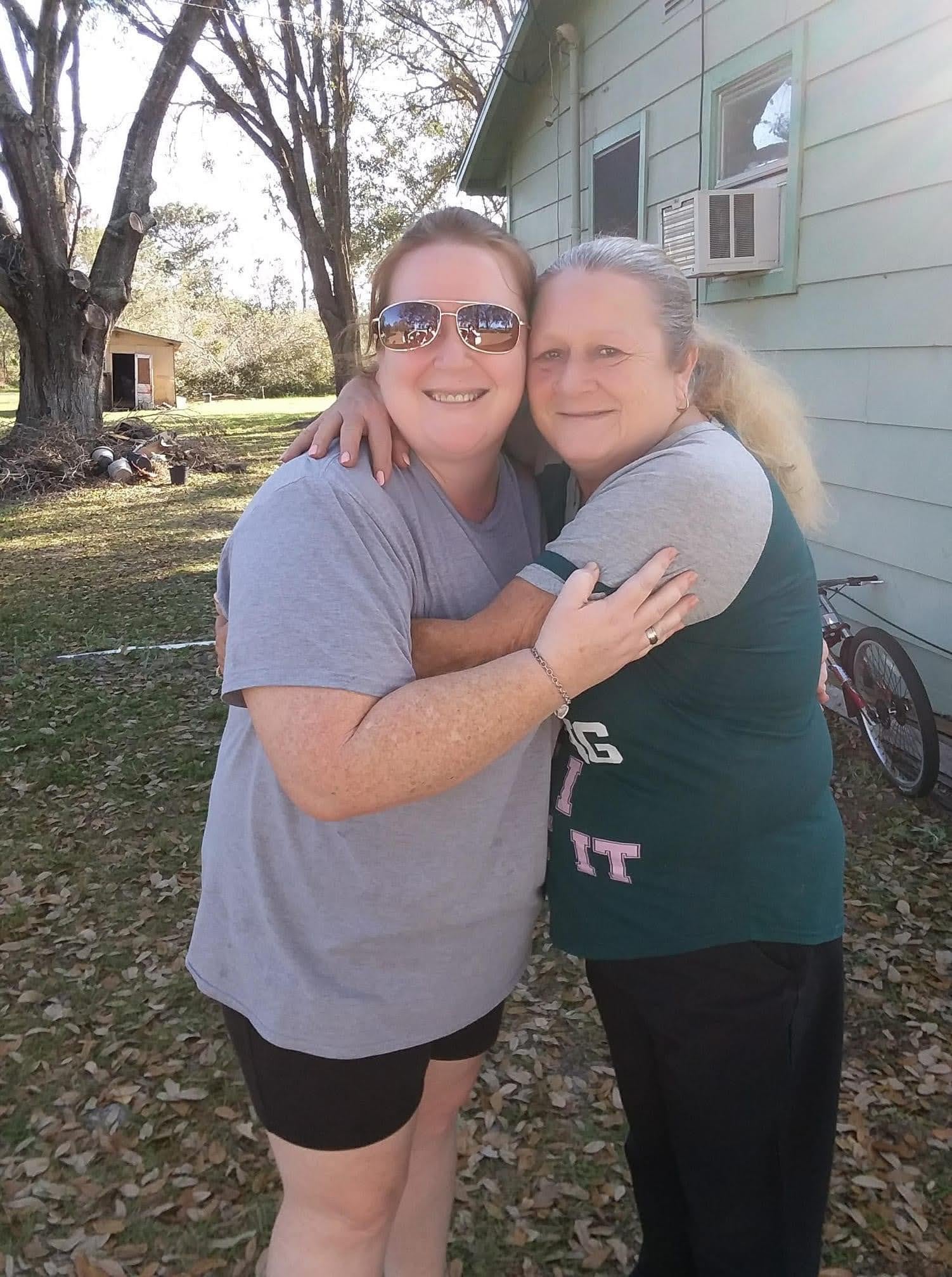 Two women hugging each other