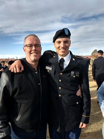 A man in uniform with his arm around another man