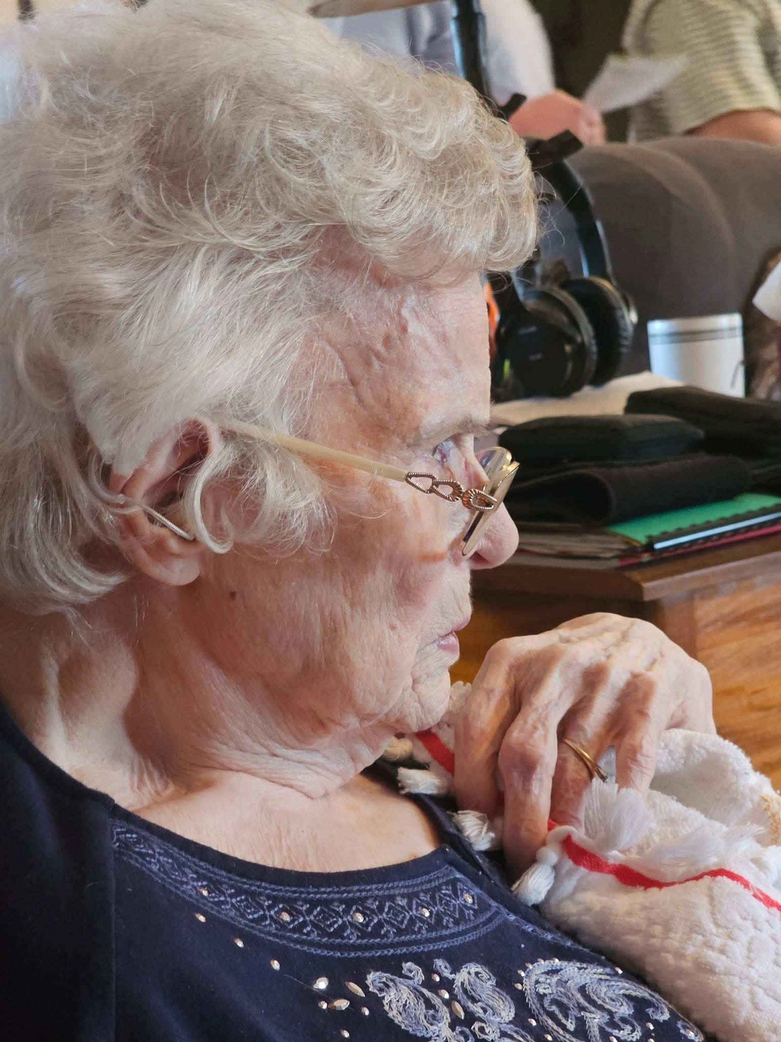 An older woman with white hair and glasses