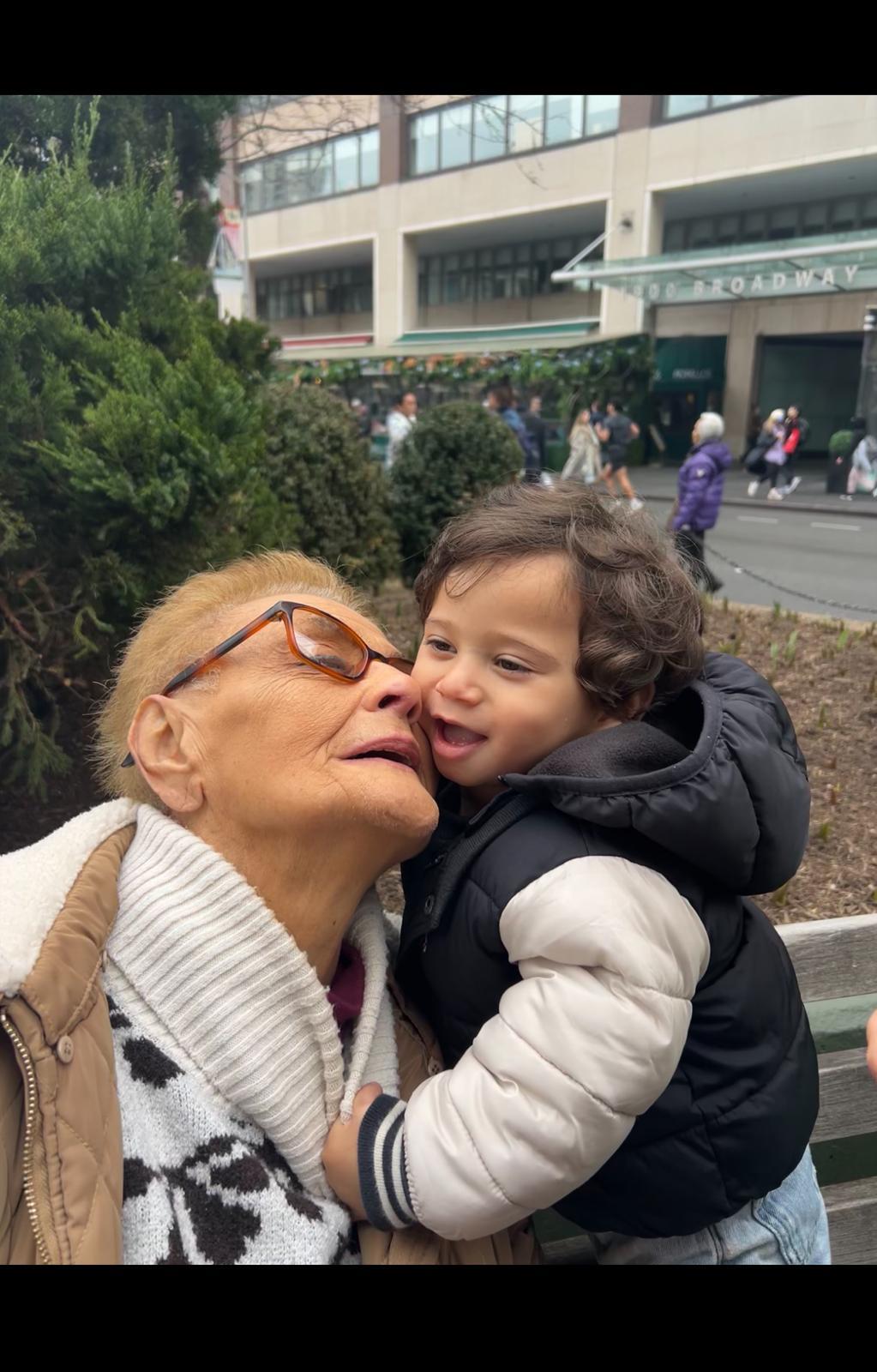 A woman holding a child on her cheek