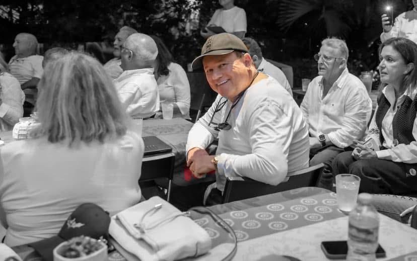 A man in a hat sitting at a table