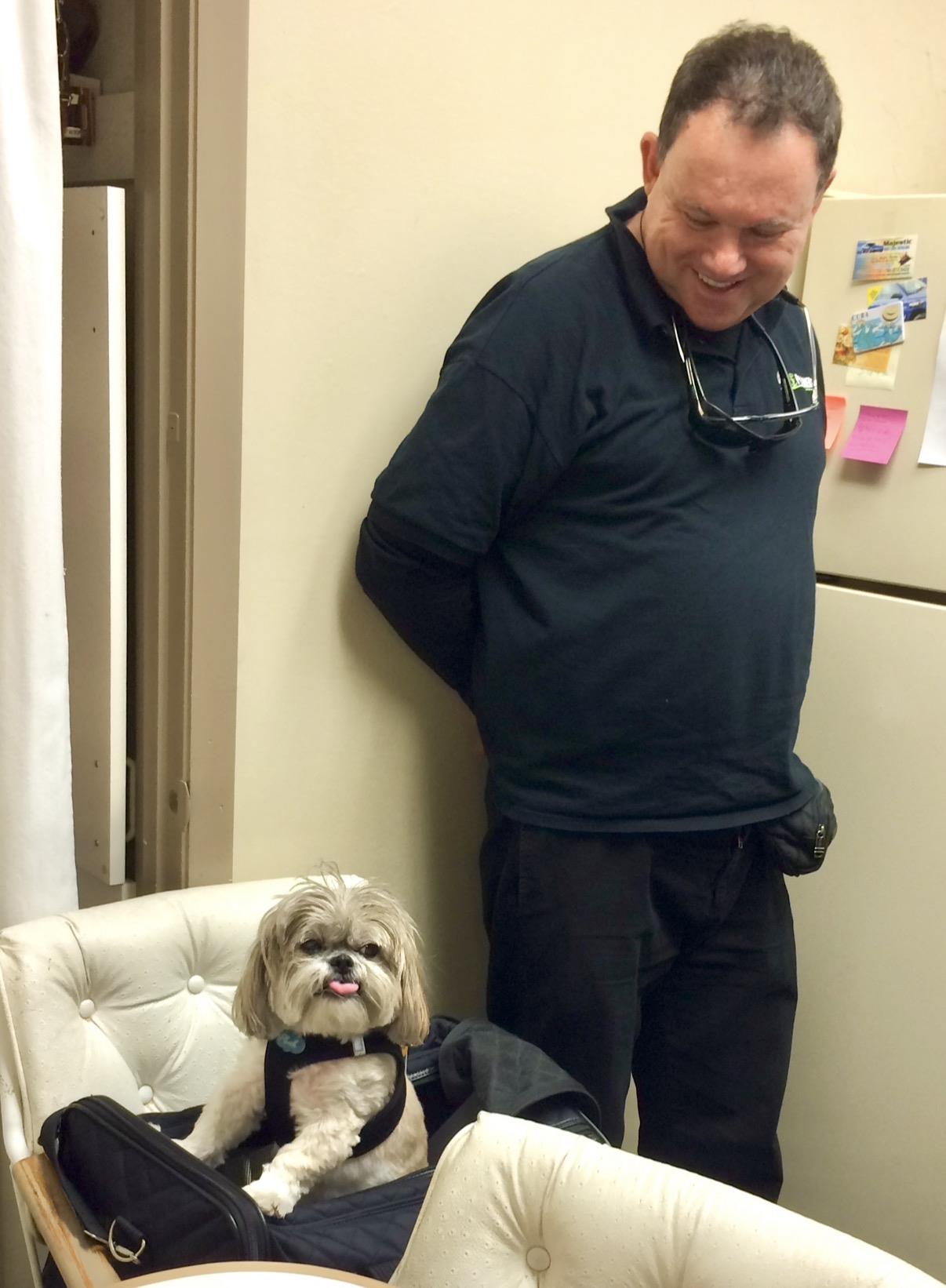 A man standing next to a dog