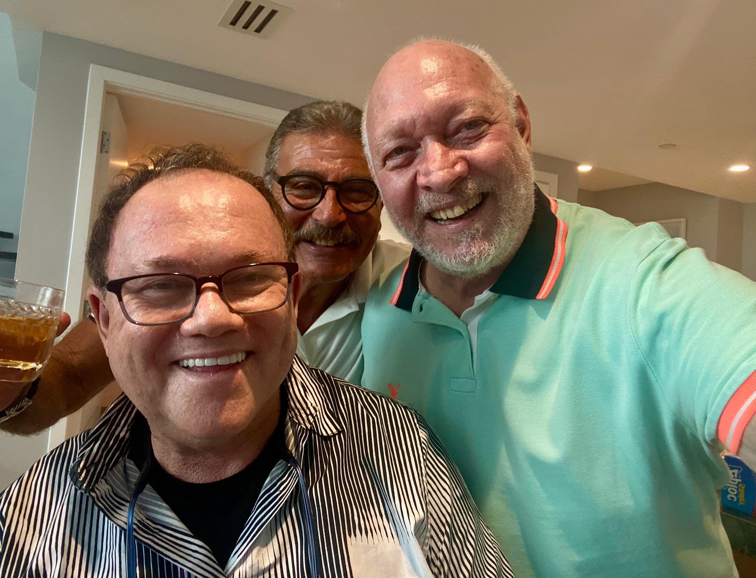 A group of men smiling for a selfie