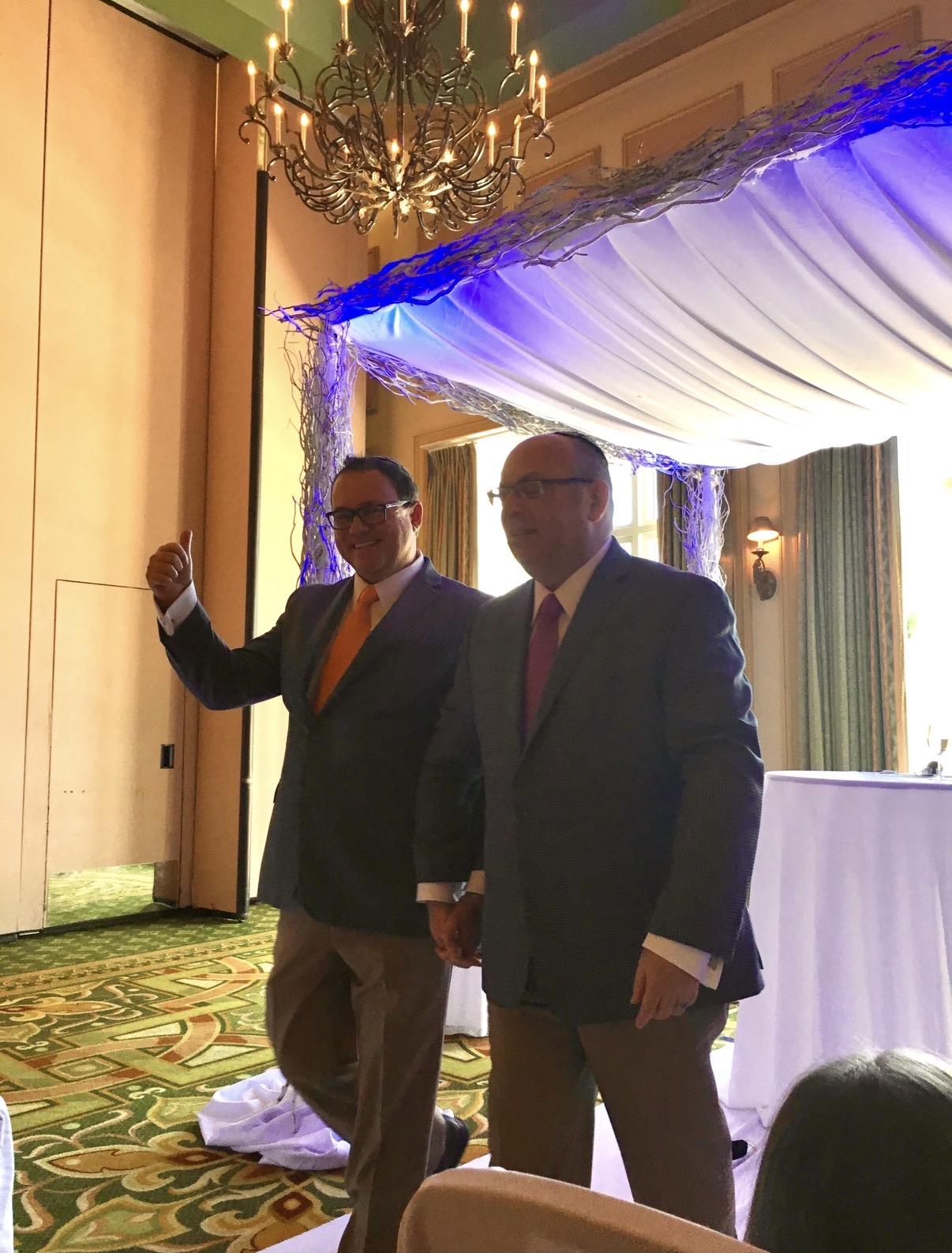 Two men in suits standing in a room