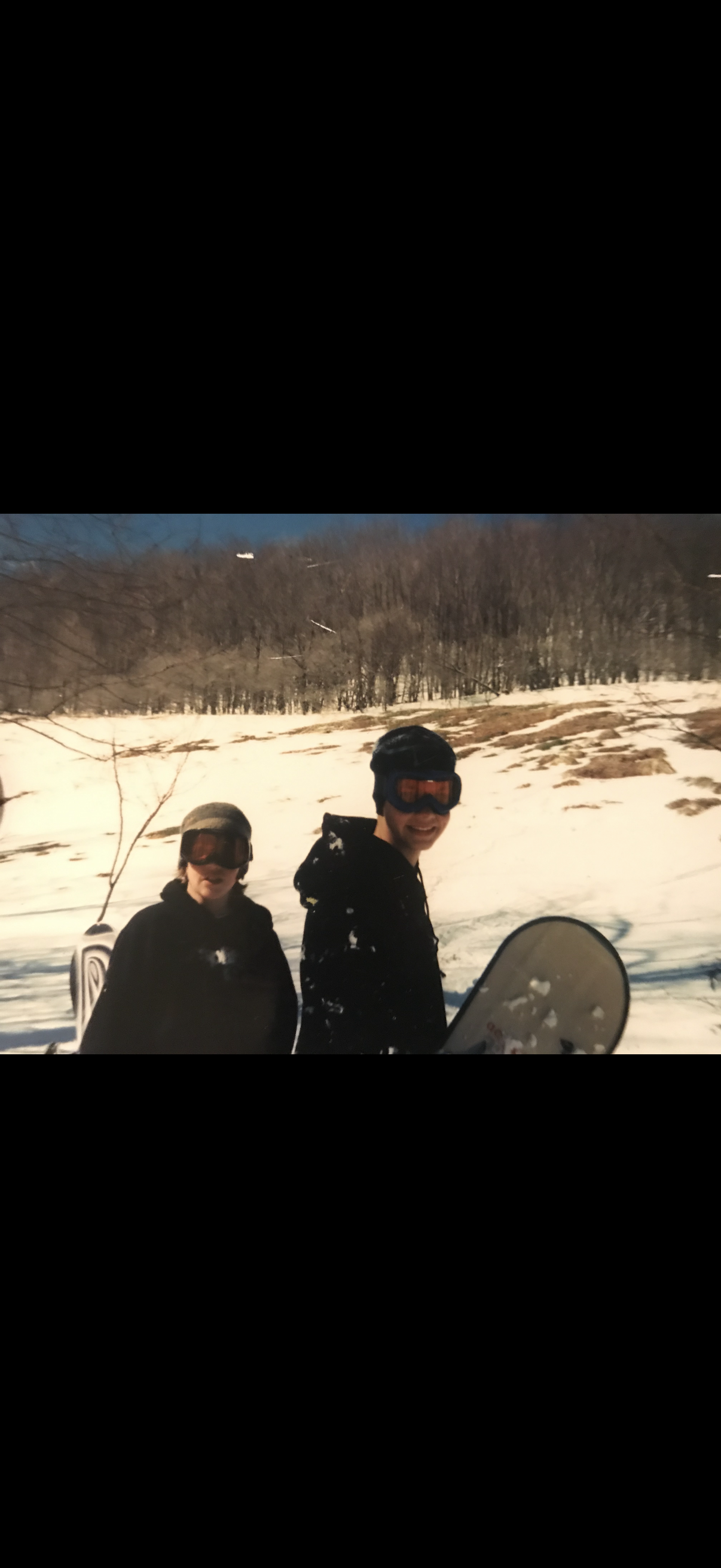 Two people standing in snow