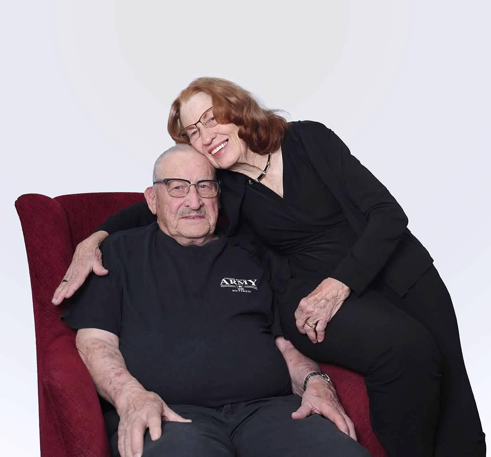 A man and woman sitting on a chair