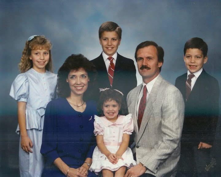 A family photo of a man woman and children