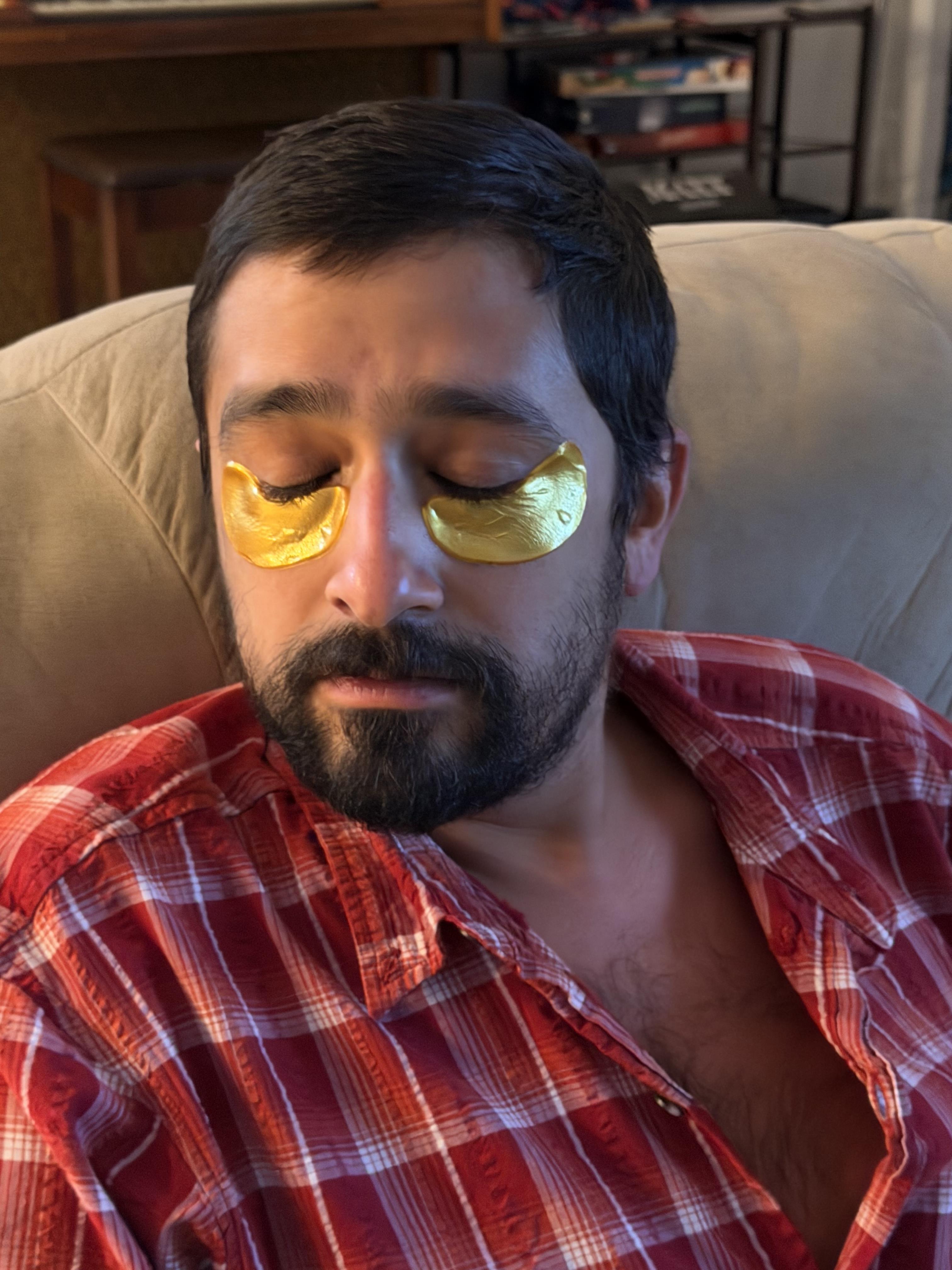 A man with gold patches on his eyes