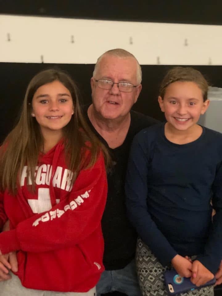 A man and two girls posing for a picture