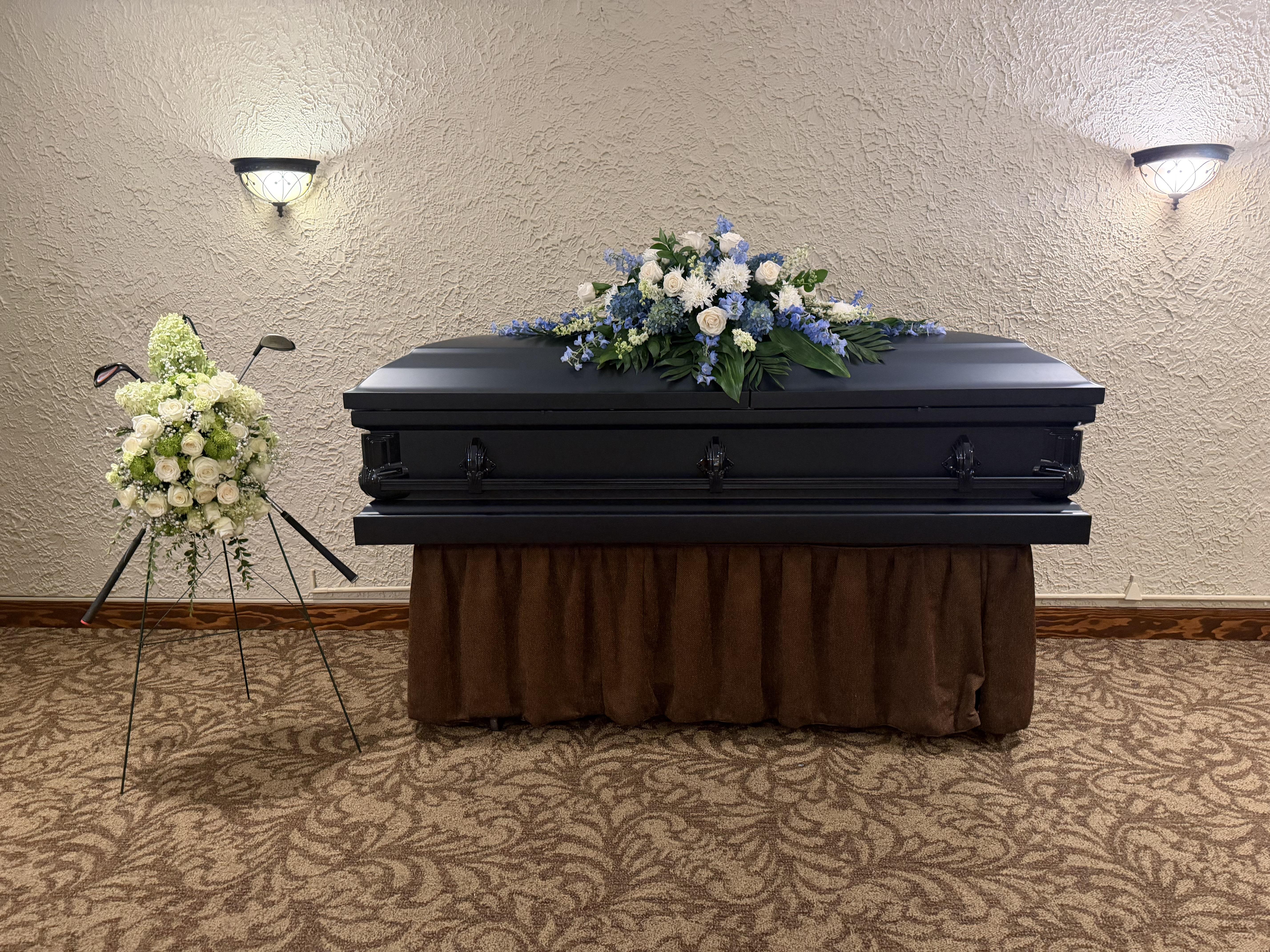 A casket with flowers on it