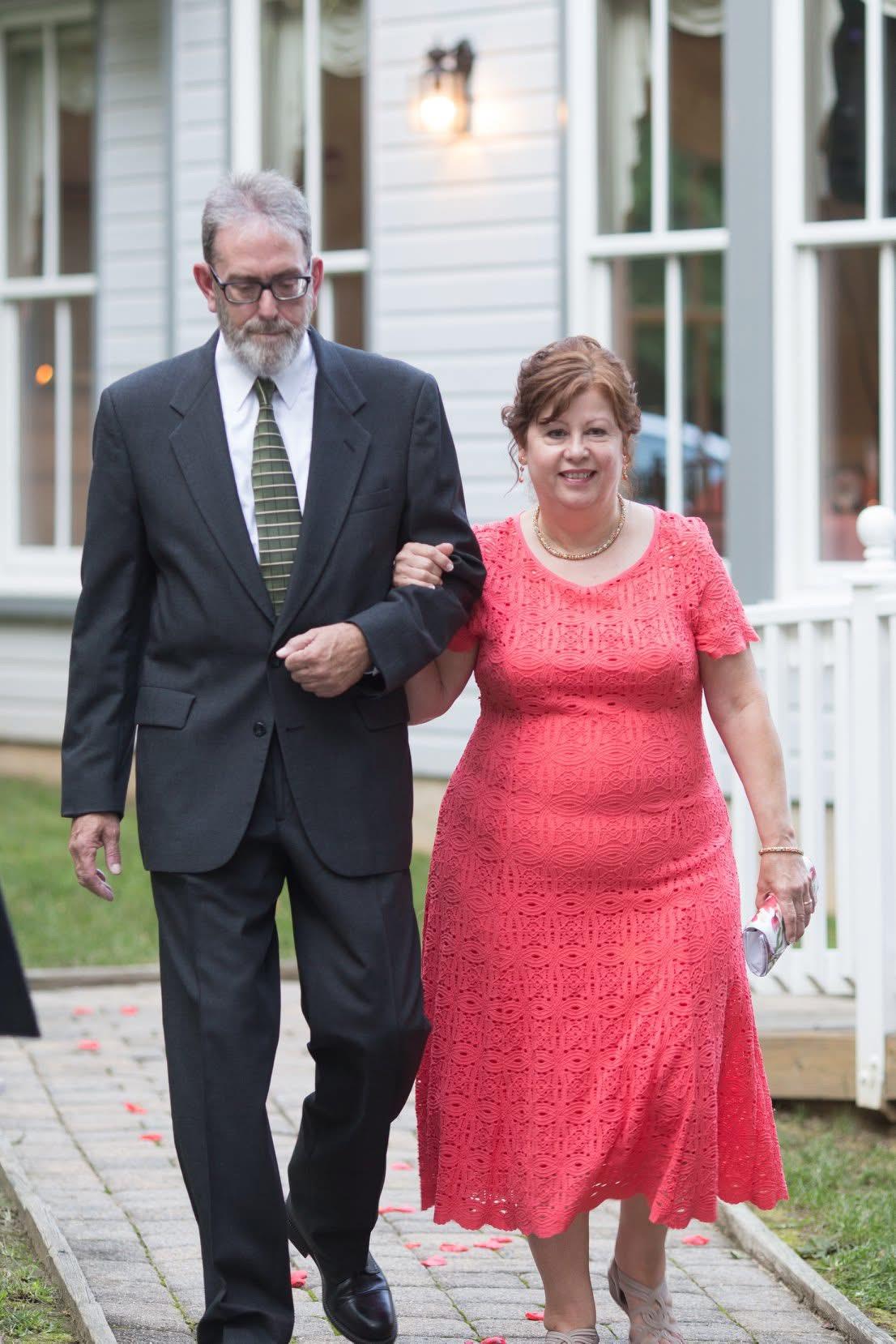A man and woman walking down a sidewalk