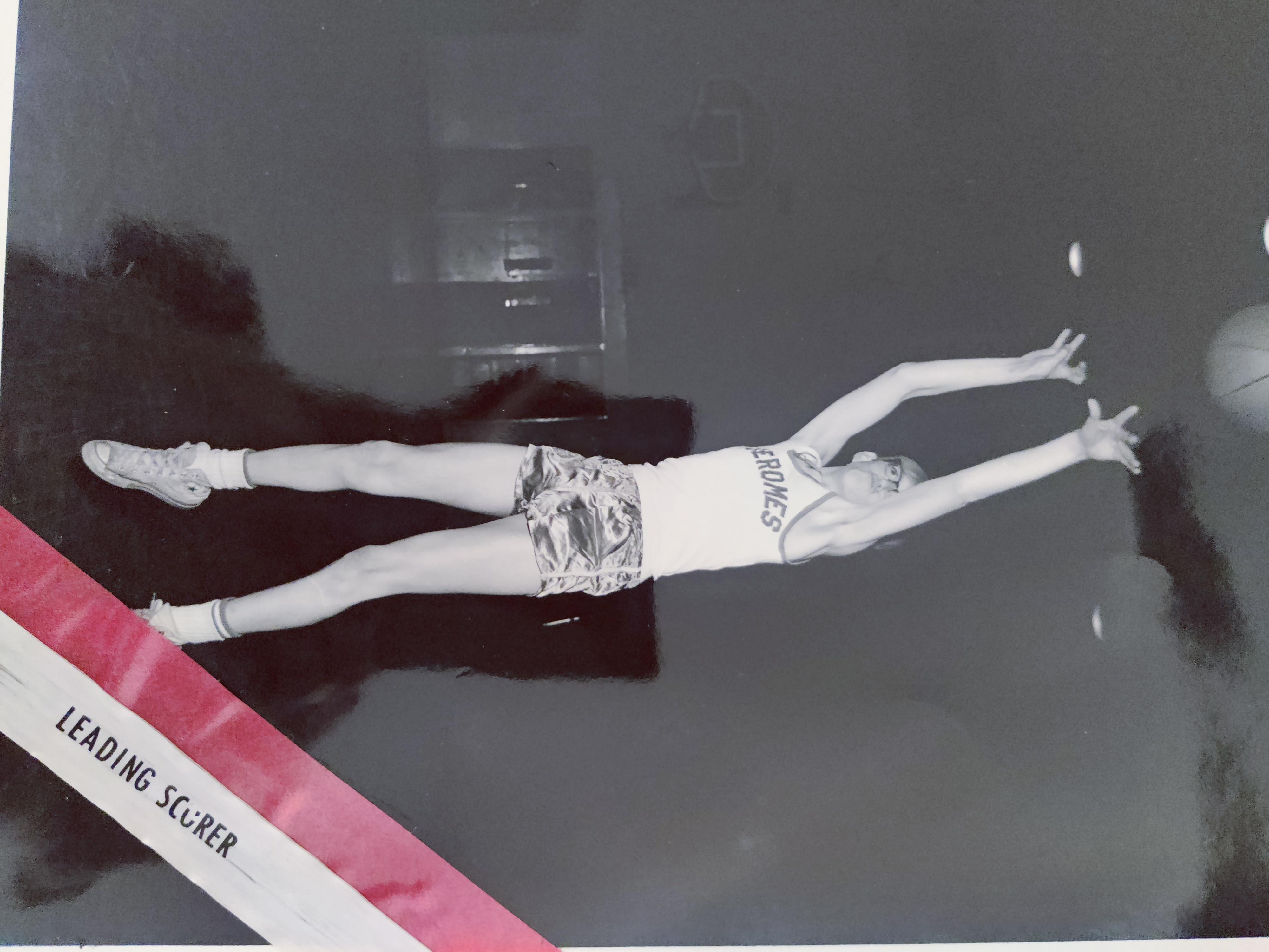 A person jumping over a red ribbon