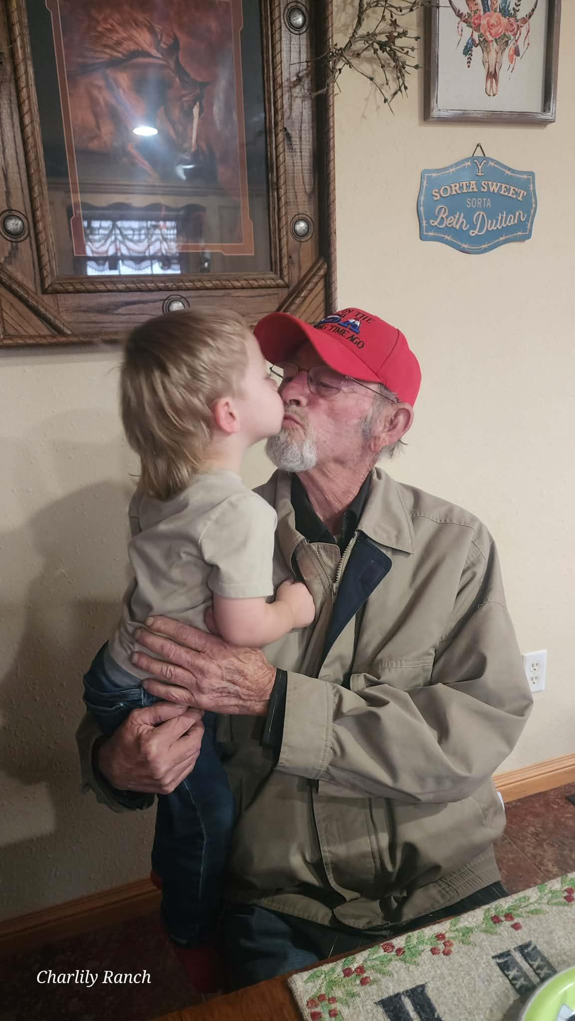 A man holding a child kissing