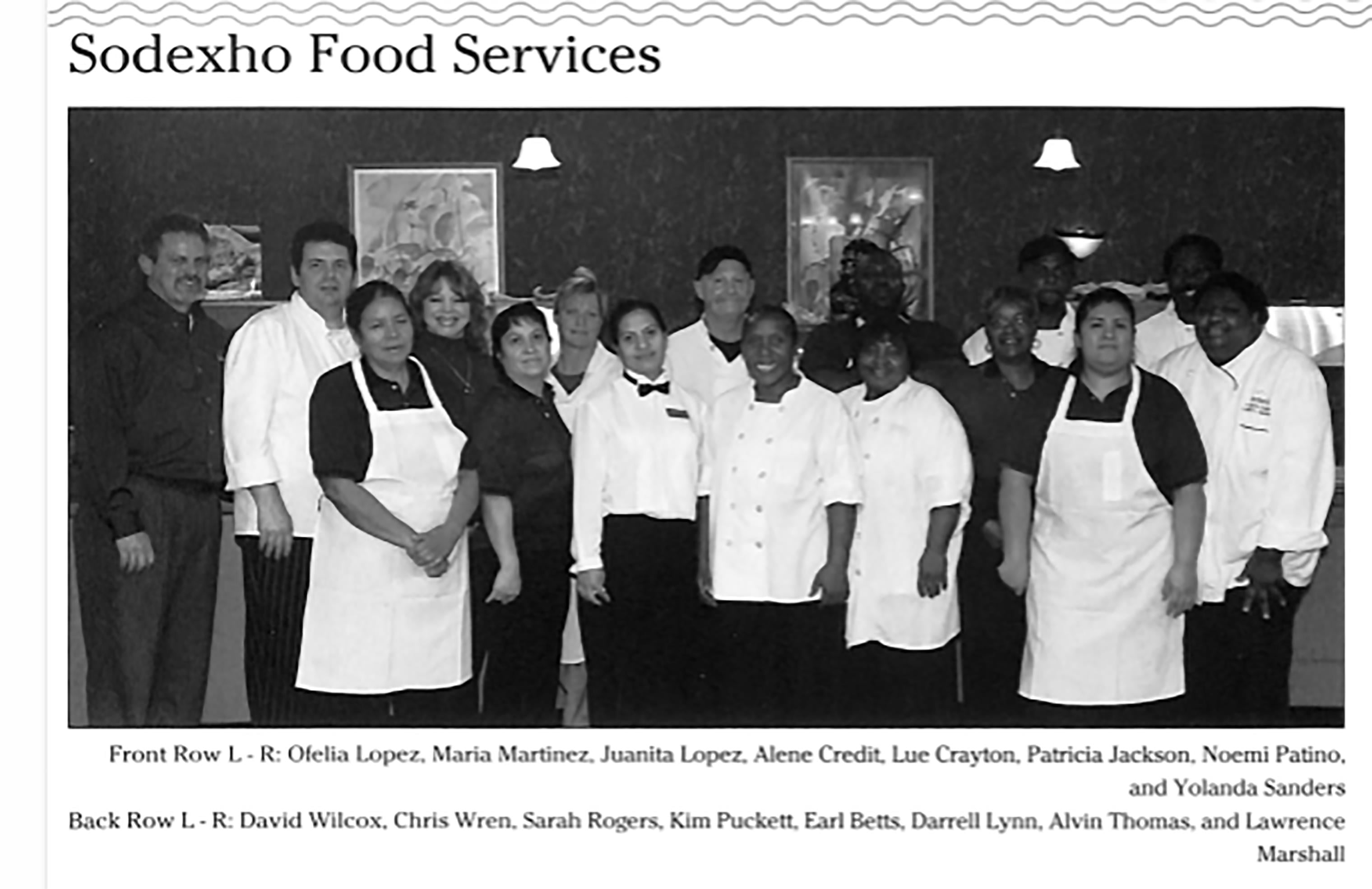 A group of people wearing white aprons