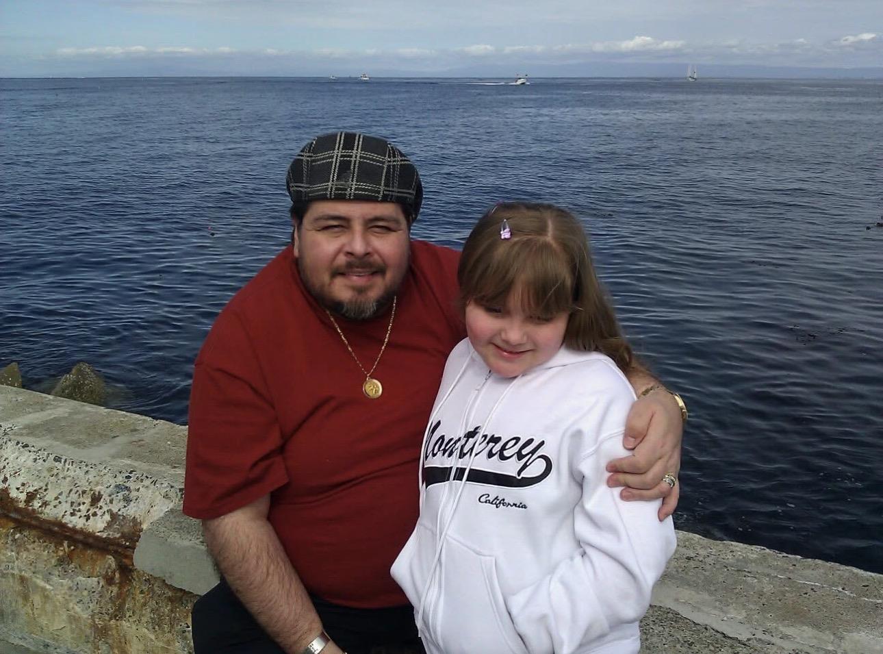 A man and a girl posing for a picture