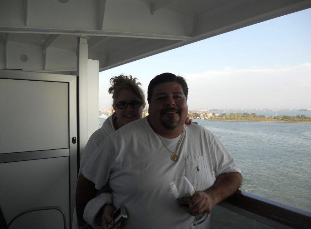 A man and woman standing on a boat