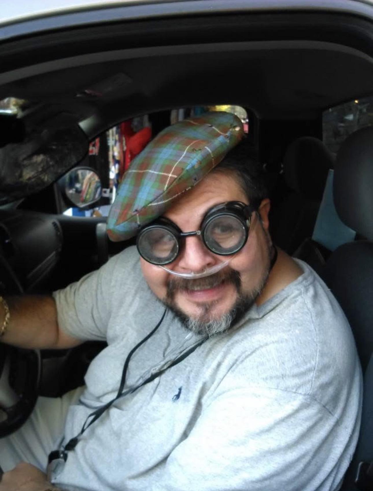 A man wearing goggles and a hat