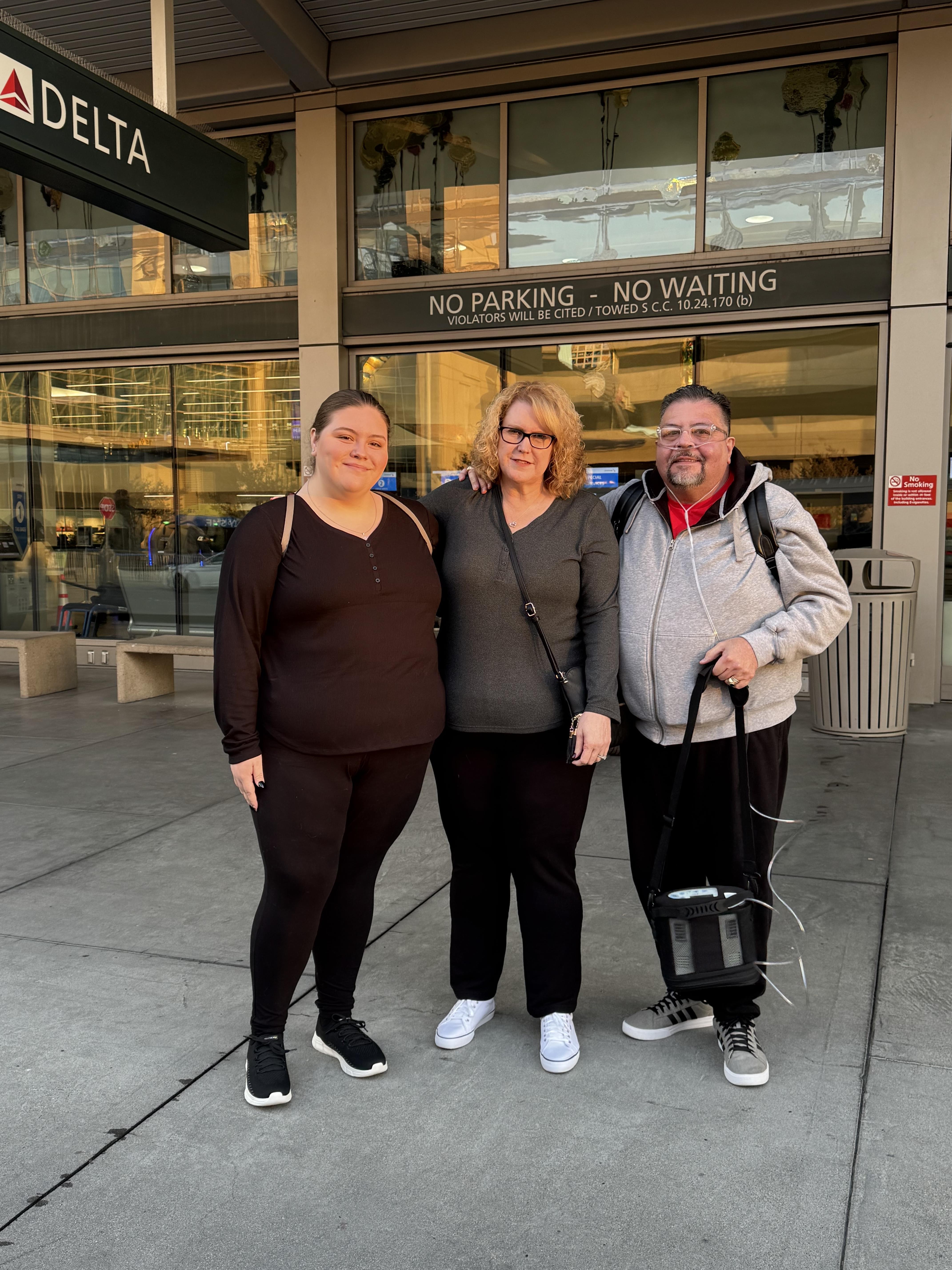 A group of people standing in front of a building