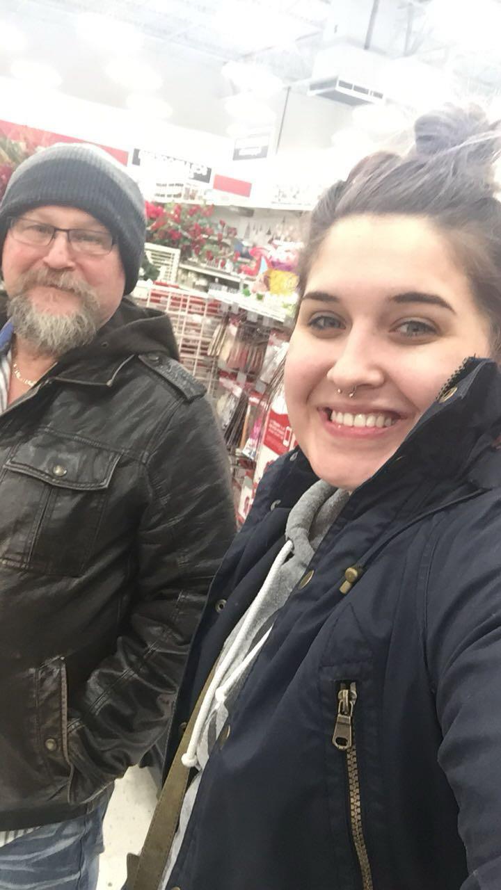 A woman taking a selfie with a man in a store
