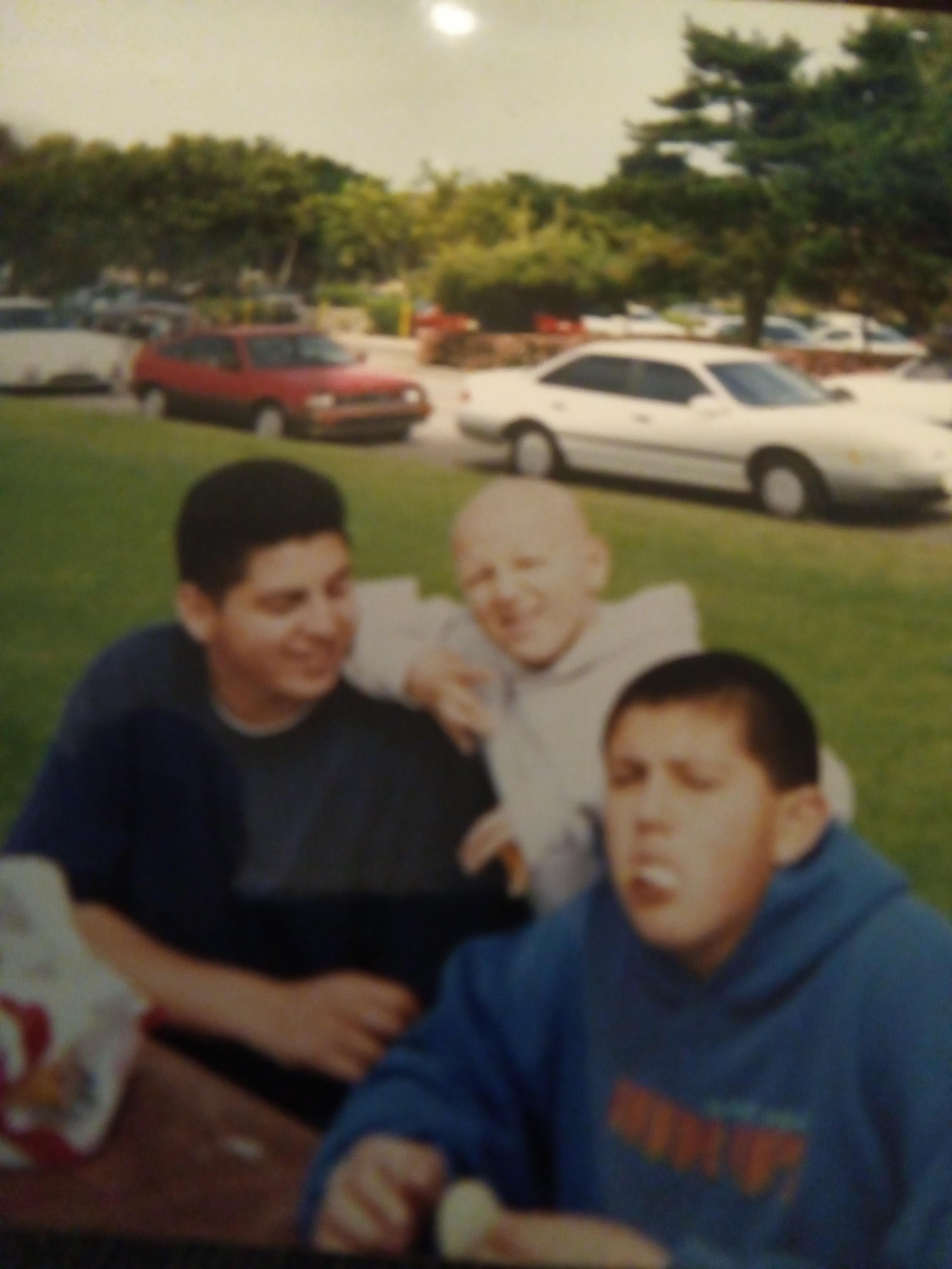 A group of boys sitting on a picnic table