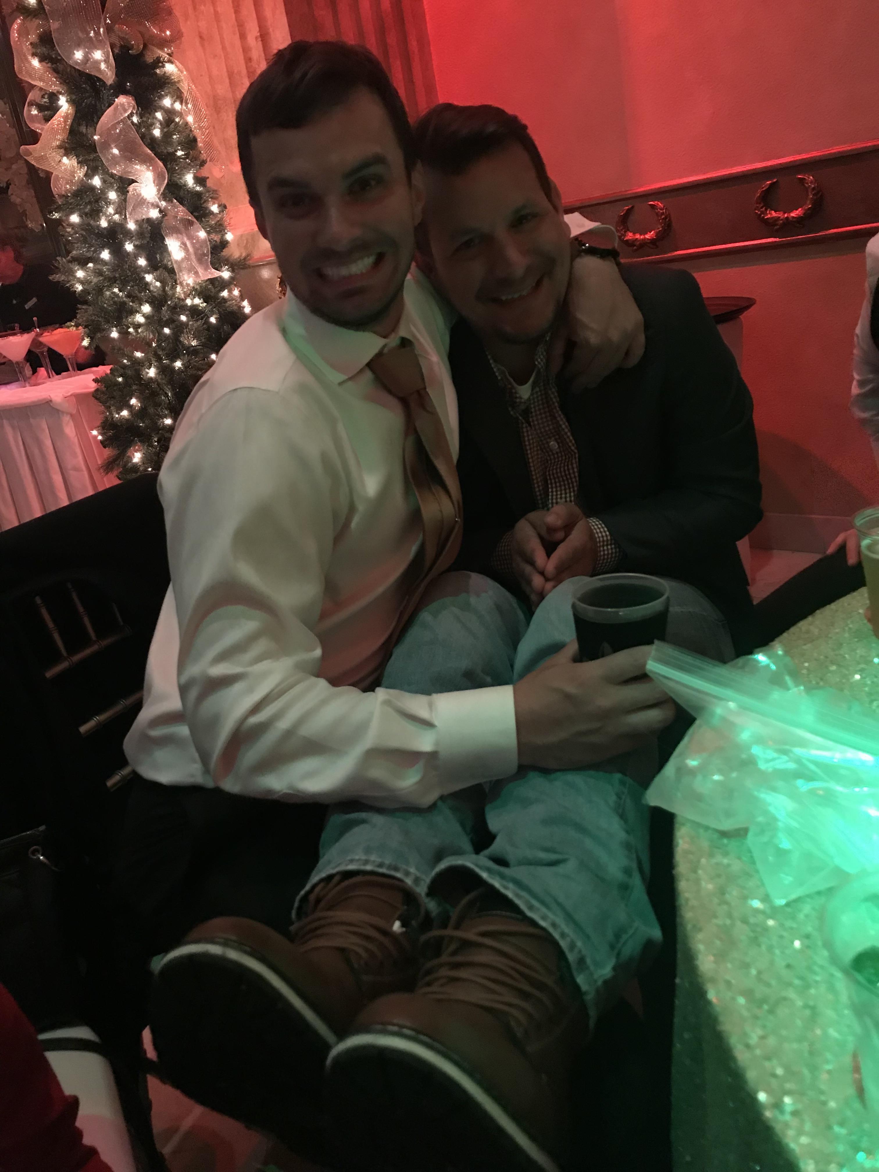 Two men sitting together smiling