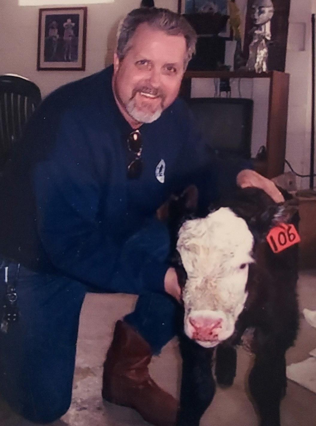 A man holding a calf