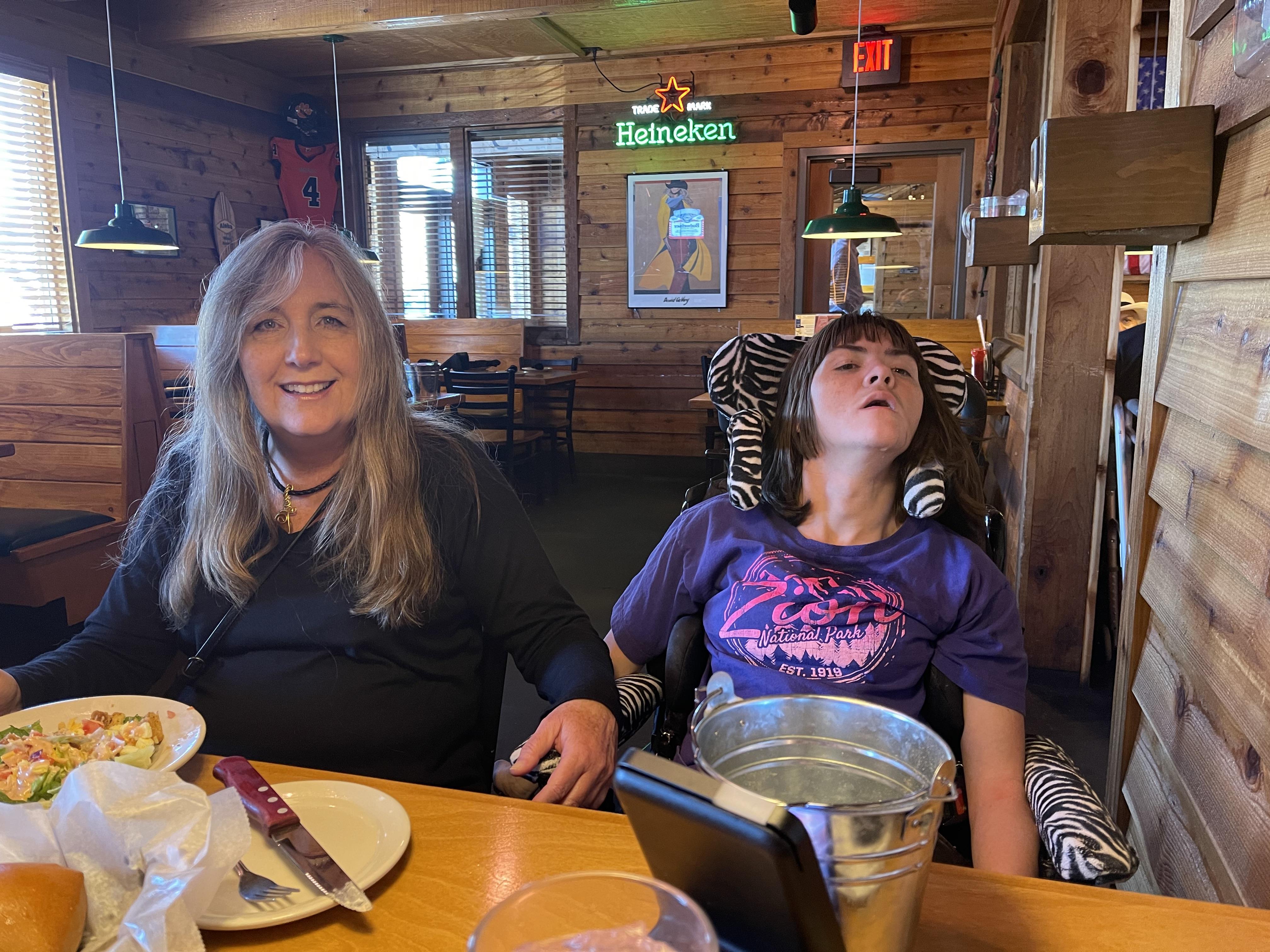 A woman and a girl sitting at a table