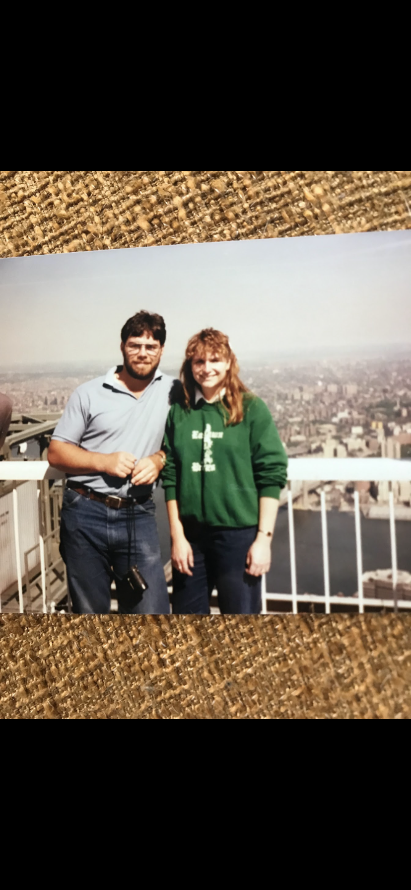 A man and woman standing on a balcony
