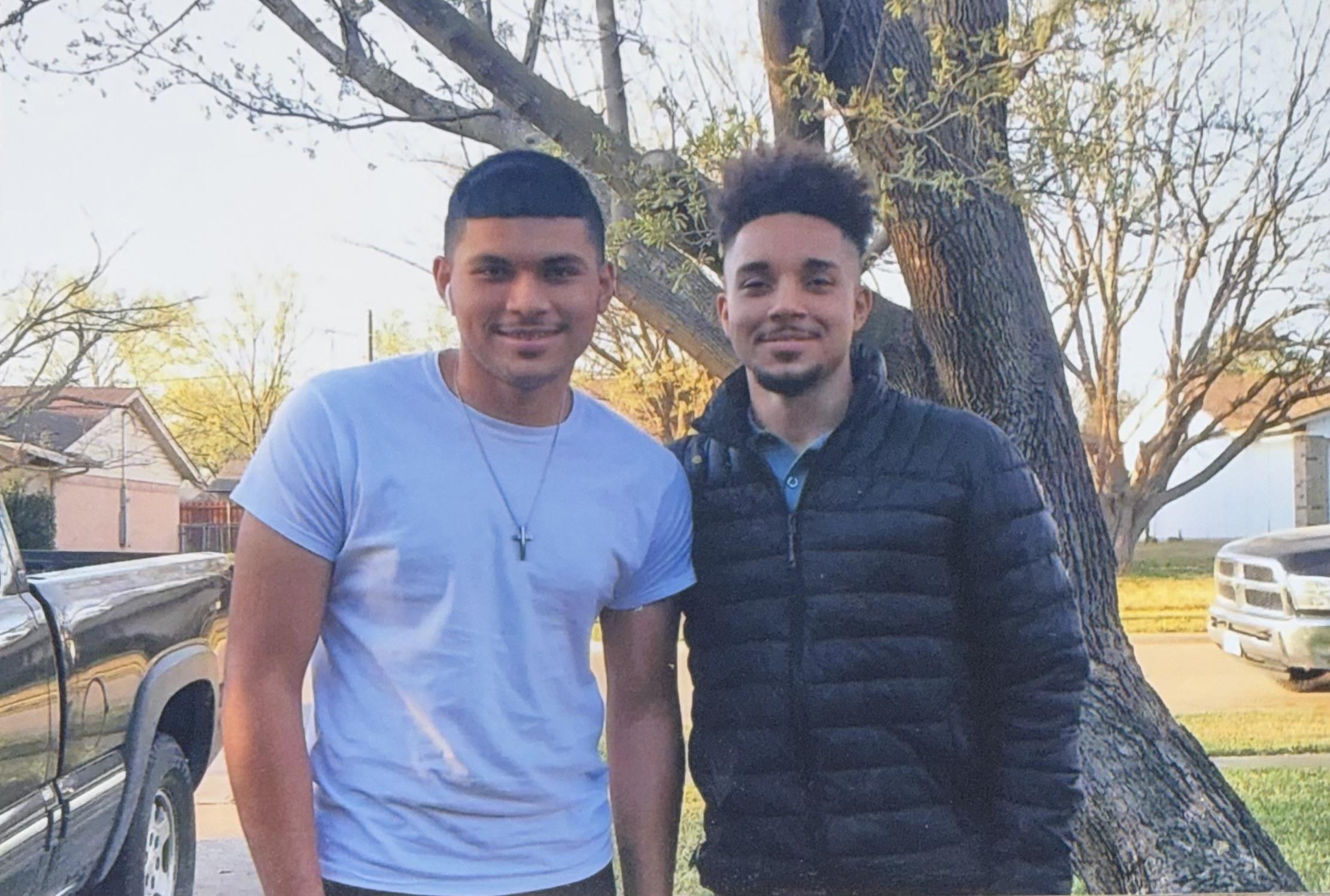 Two men standing next to each other