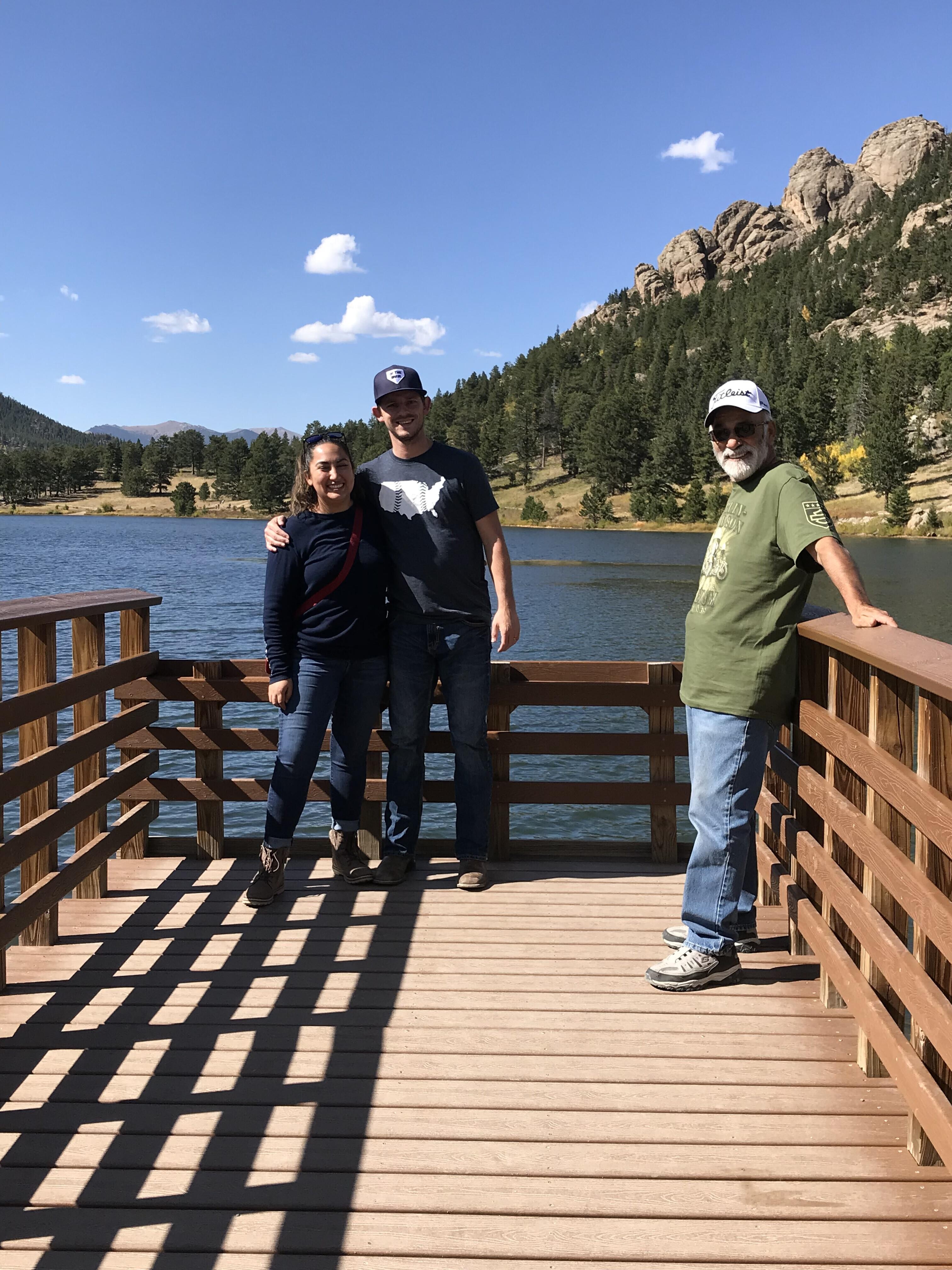 A group of people standing on a wooden deck